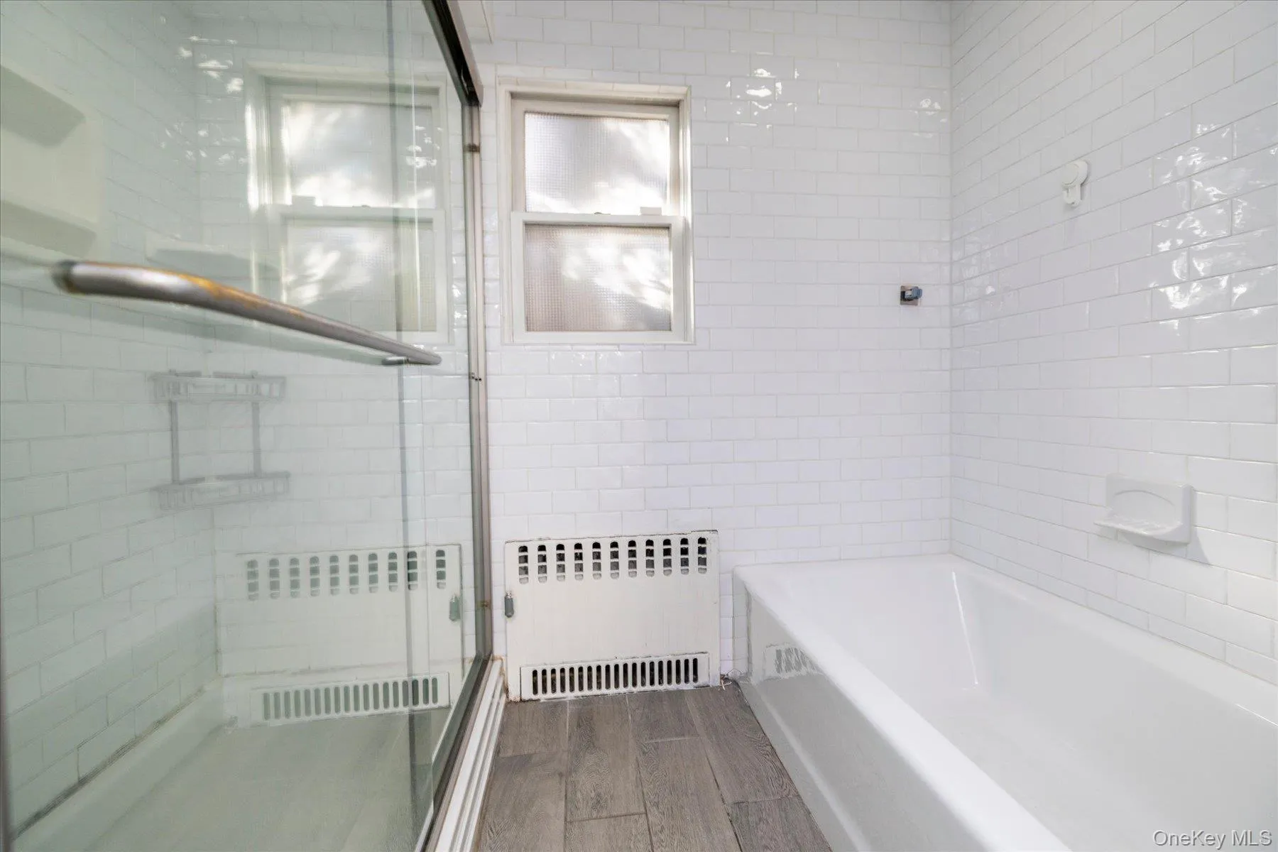 main floor bathroom featuring a tub and shower main floor bathroom featuring a tub and shower