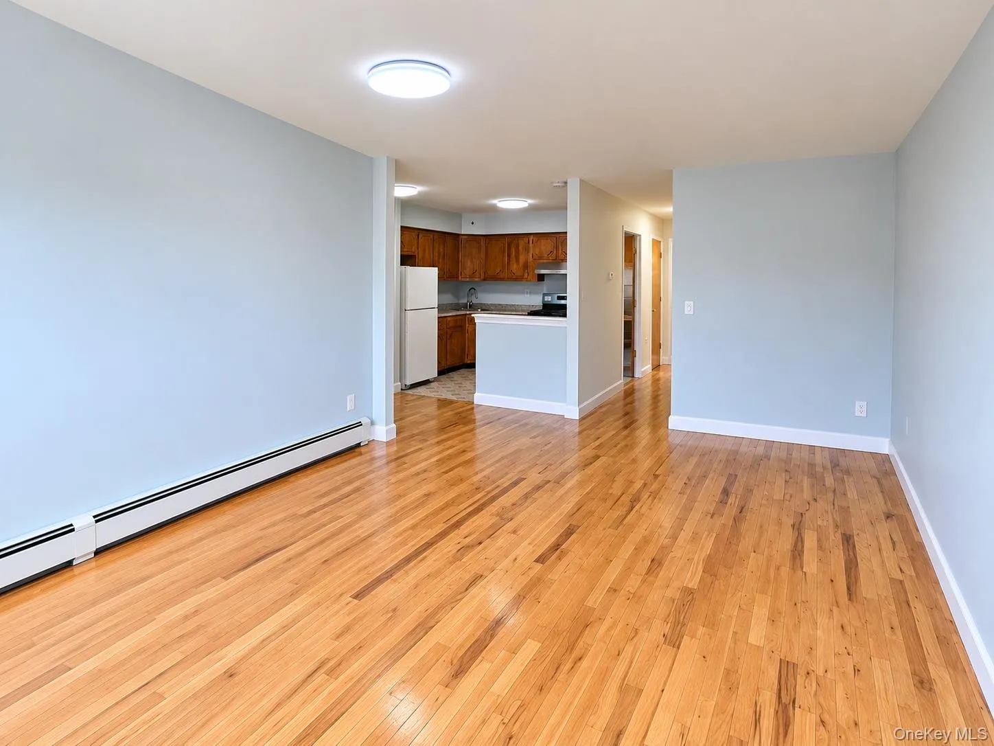 Spacious living and dining area with hardwood floors and abundant natural light. Spacious living and dining area with hardwood floors and abundant natural light.