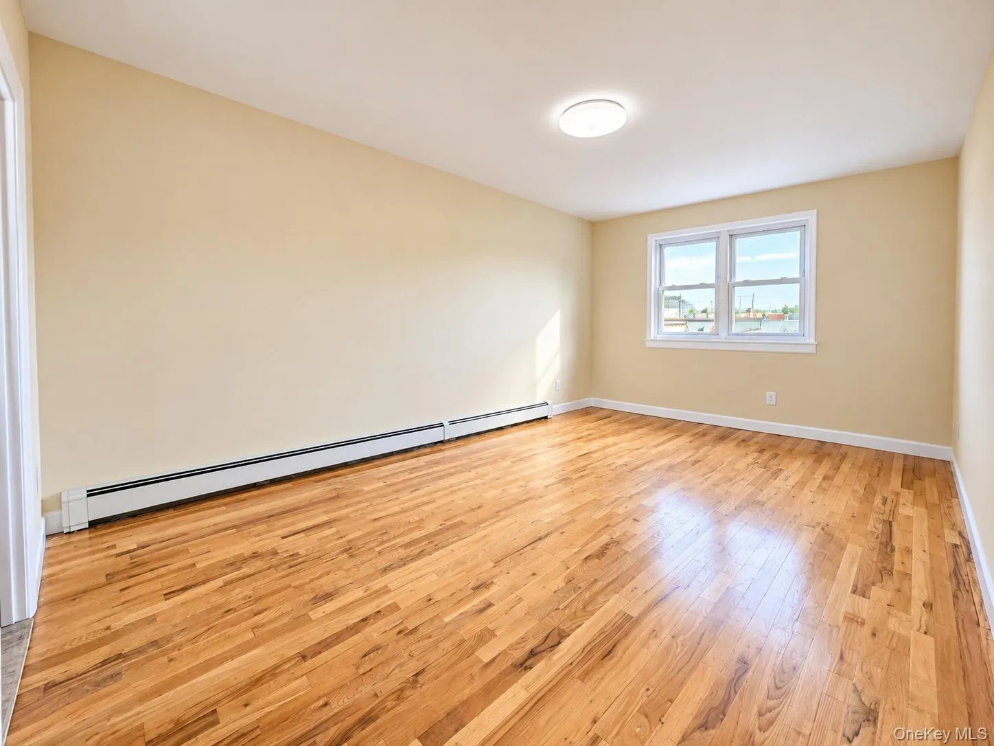 Spacious primary bedroom with hardwood floors and natural light. Spacious primary bedroom with hardwood floors and natural light.