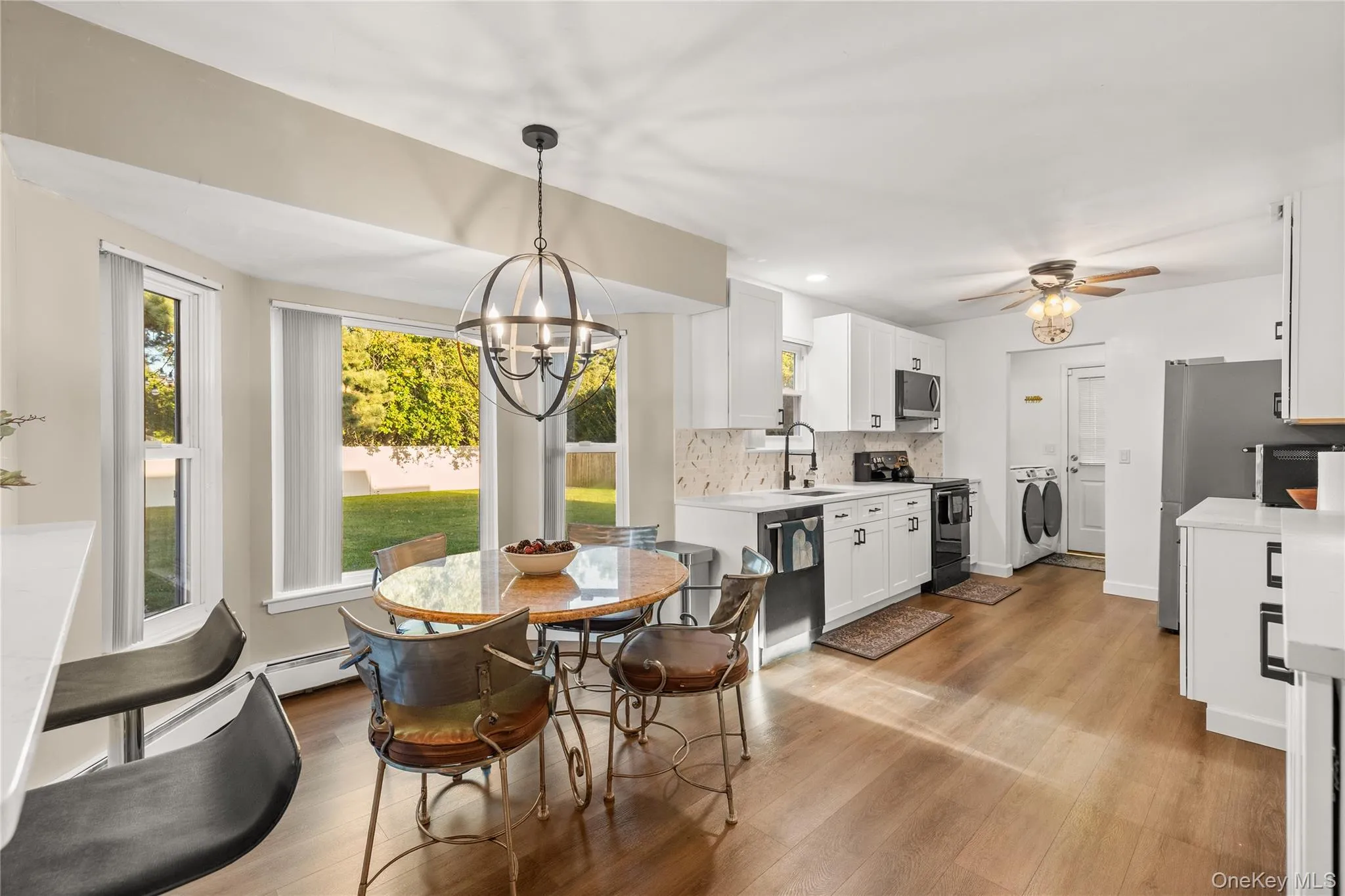 Wood-finish flooring throughout, white cabinetry, white quartz counter tops, and stainless steel appliances Wood-finish flooring throughout, white cabinetry, white quartz counter tops, and stainless steel appliances