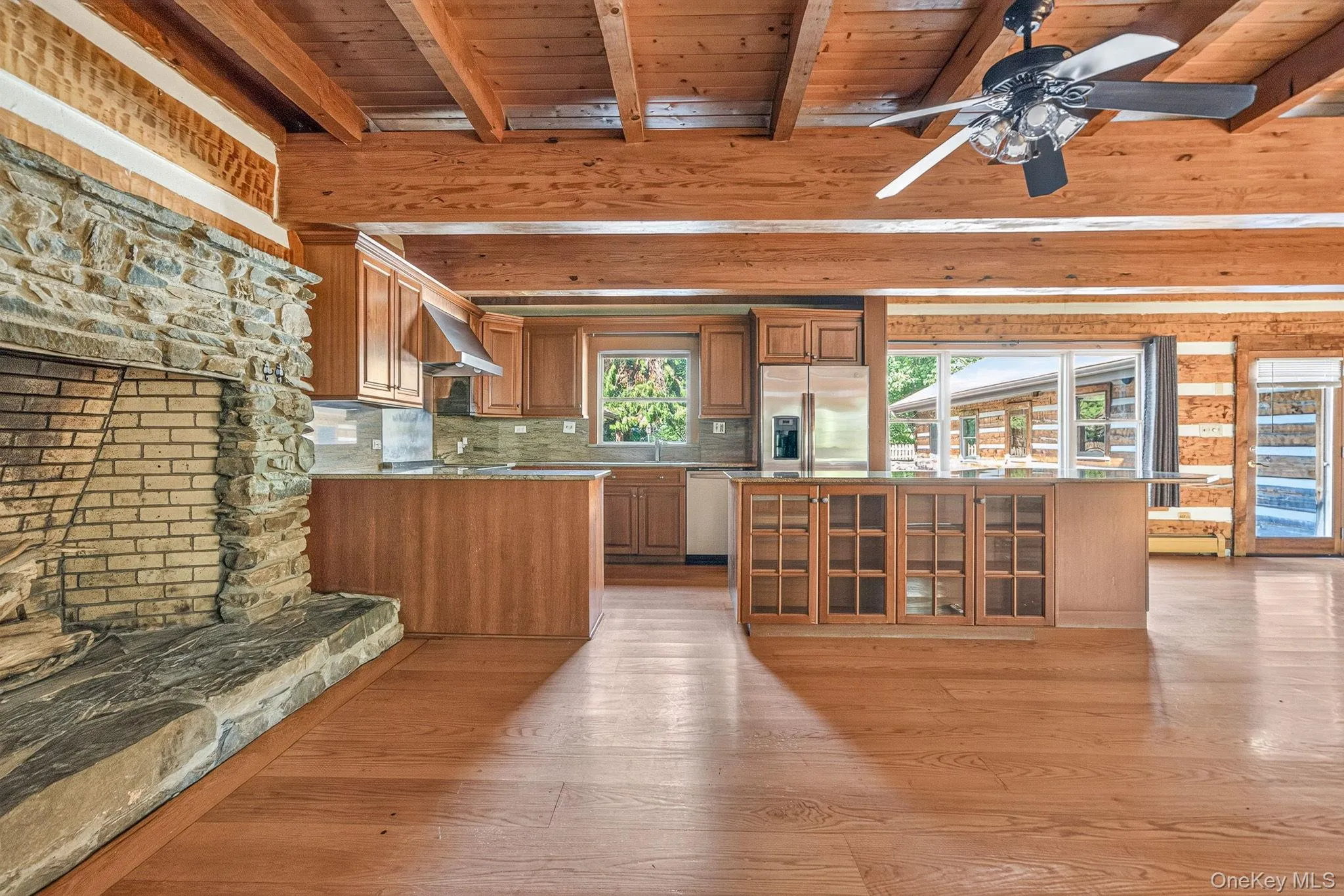 Kitchen and dining area with generous stone fireplace. Kitchen and dining area with generous stone fireplace.