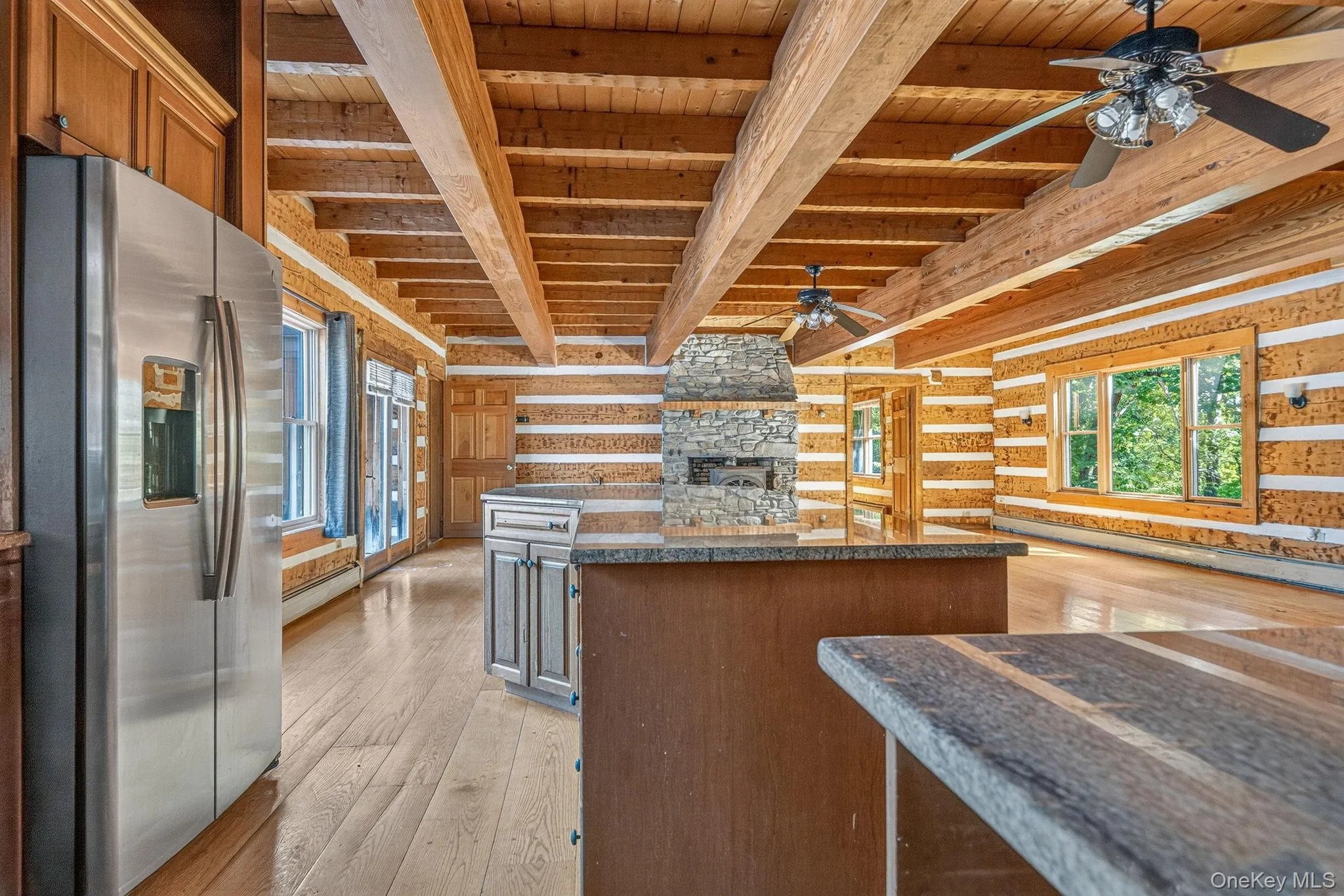 Kitchen looking to family room area with Jotul wood burning stove within the second stone fireplace. Kitchen looking to family room area with Jotul wood burning stove within the second stone fireplace.