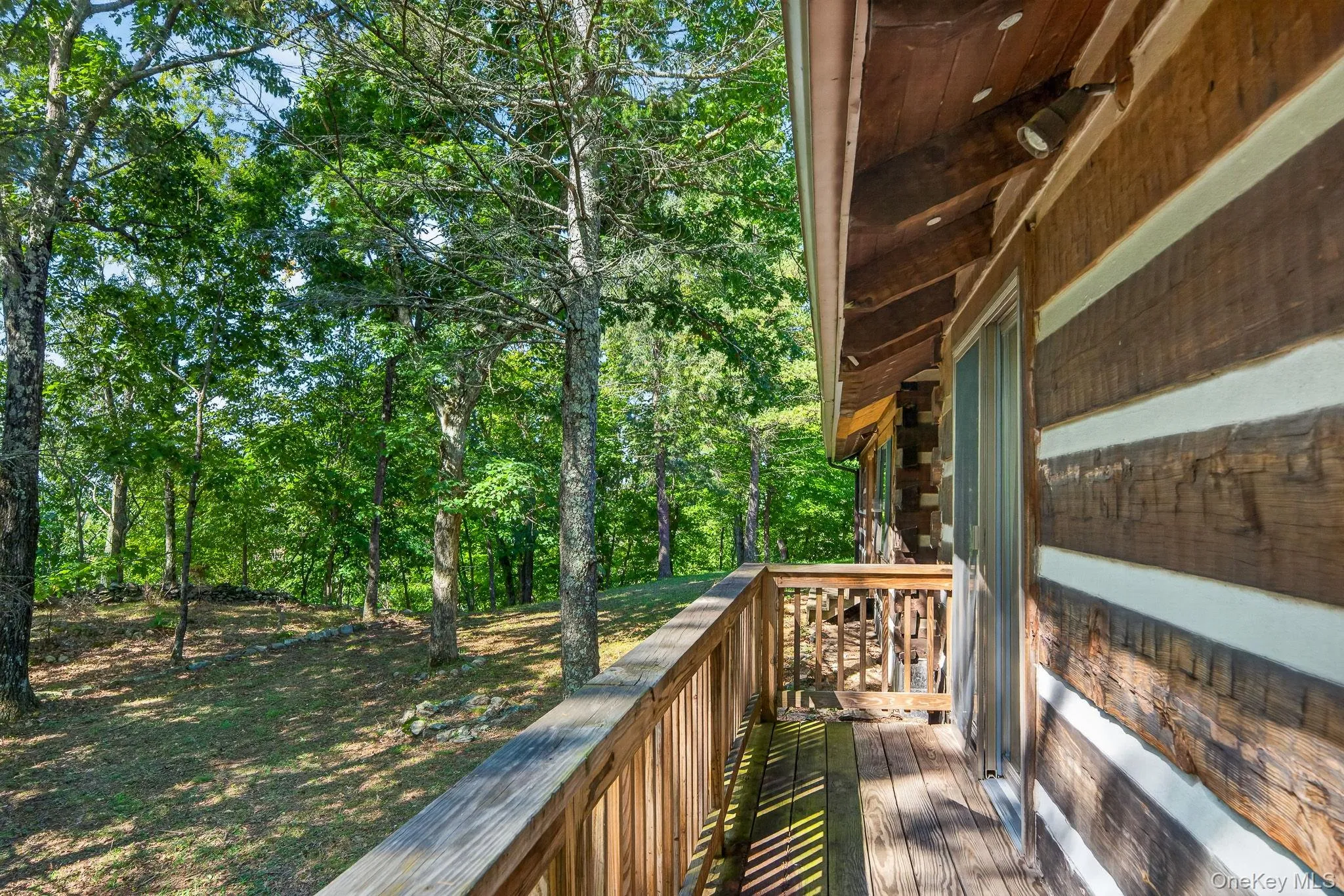 Balcony off game room. Firepit and stone wall dots the landscape. Balcony off game room. Firepit and stone wall dots the landscape.