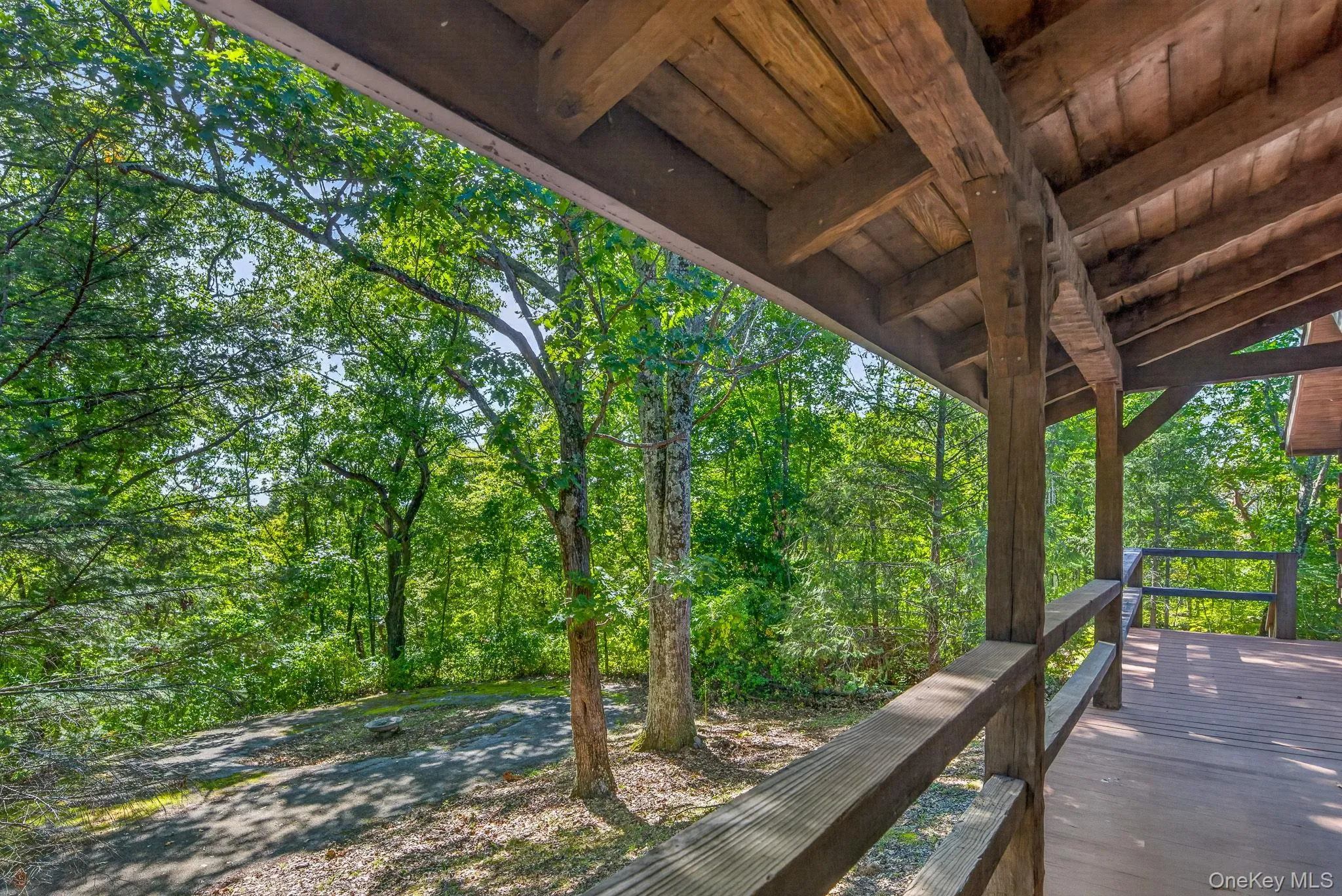 Front porch looking to circular driveway and natural surroundings. Front porch looking to circular driveway and natural surroundings.