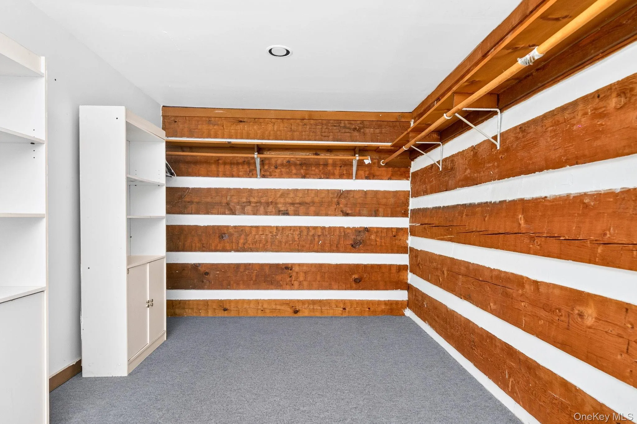 Primary bedroom walk-in closet Primary bedroom walk-in closet