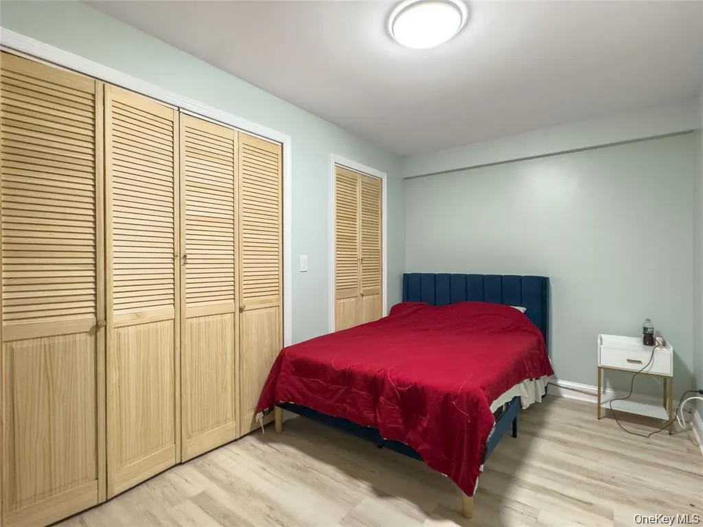 Wood-finish flooring, louvered bi-fold closet doors, and flush-mount ceiling lighting Wood-finish flooring, louvered bi-fold closet doors, and flush-mount ceiling lighting