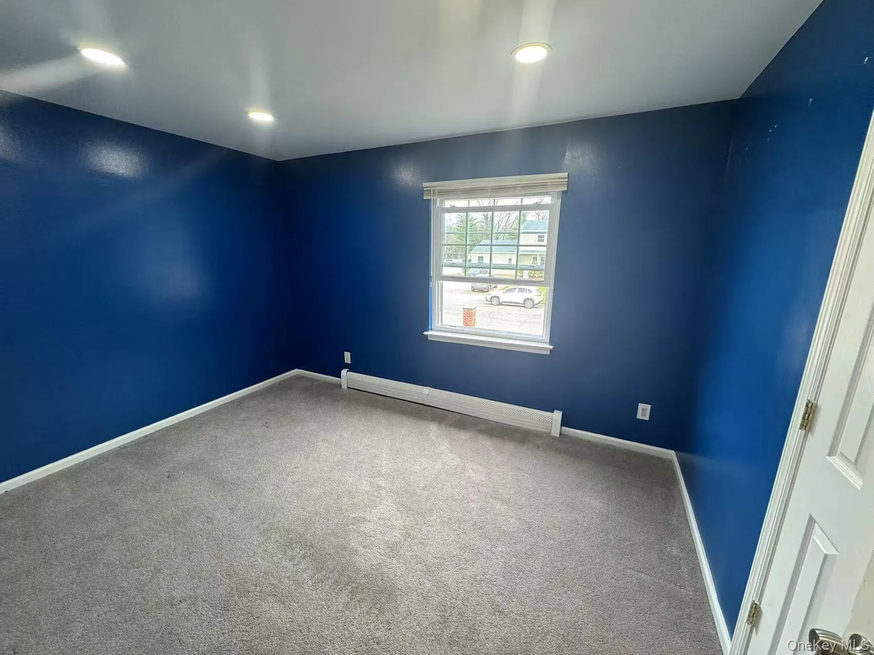 Carpeted spare room with baseboards, a baseboard heating unit, and recessed lighting Carpeted spare room with baseboards, a baseboard heating unit, and recessed lighting