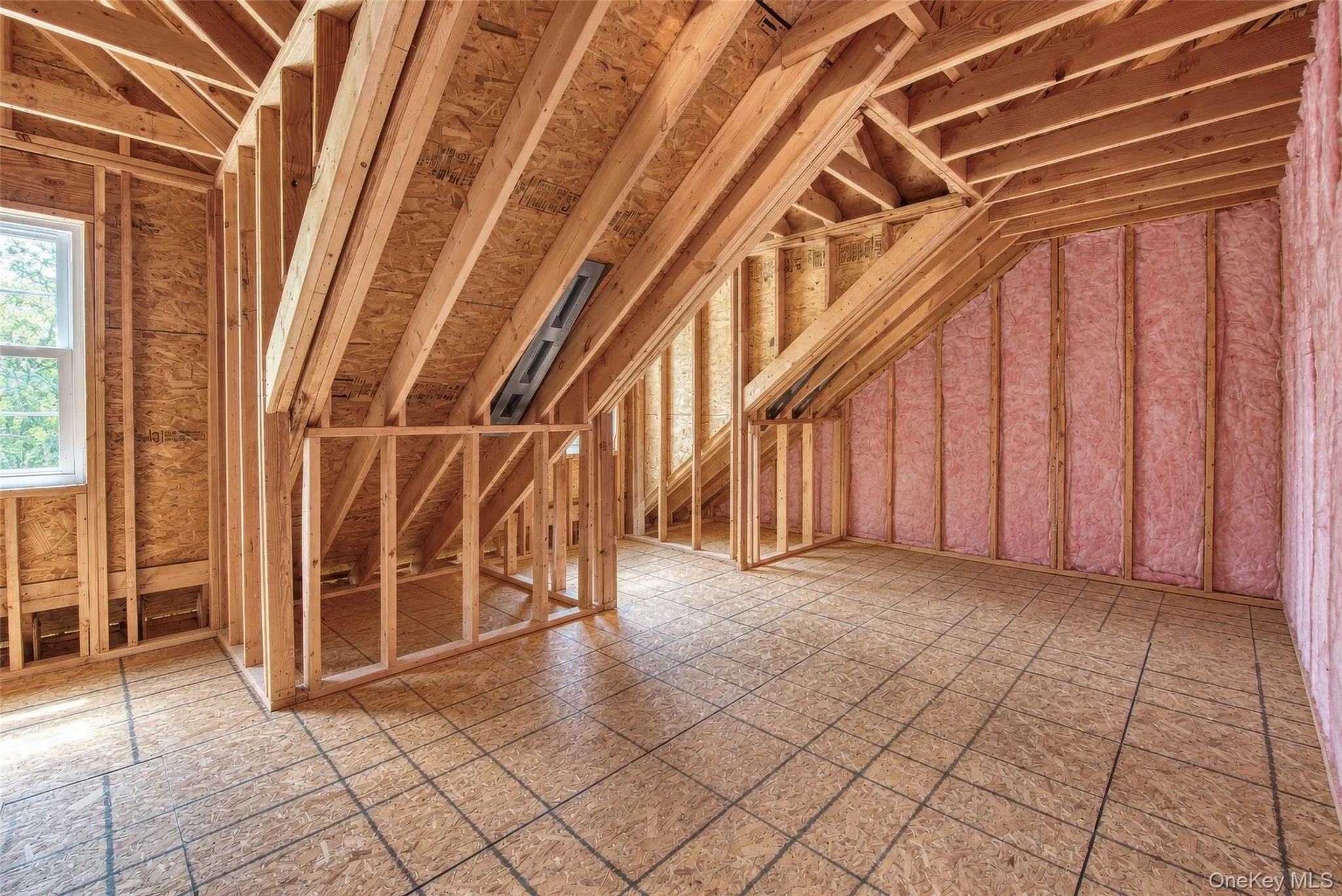 Unfinished 2nd floor space featuring wood framing, subflooring, and 2 windows Unfinished 2nd floor space featuring wood framing, subflooring, and 2 windows