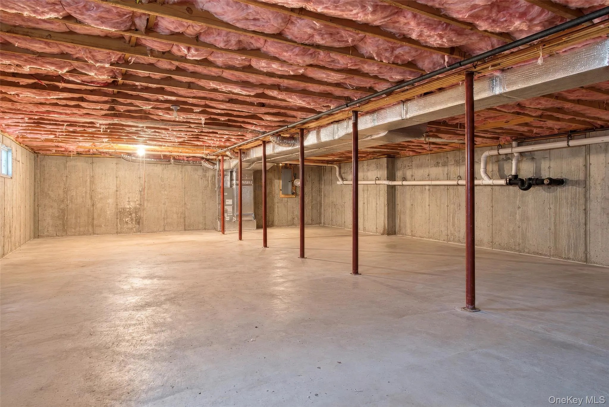 Unfinished basement with concrete walls, concrete flooring, and visible insulation Unfinished basement with concrete walls, concrete flooring, and visible insulation