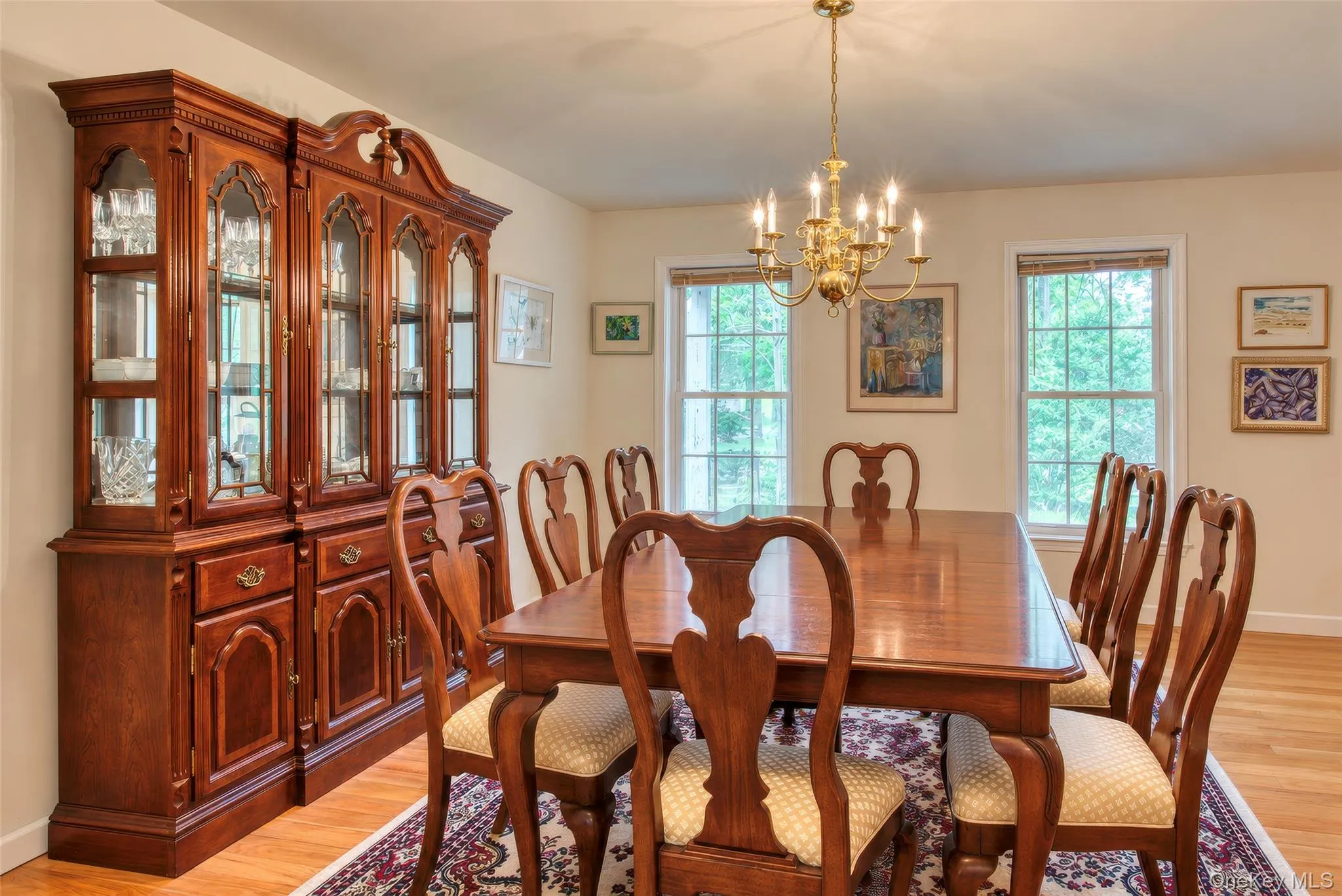 Hardwood flooring, painted walls, multiple windows, and a brass chandelier Hardwood flooring, painted walls, multiple windows, and a brass chandelier