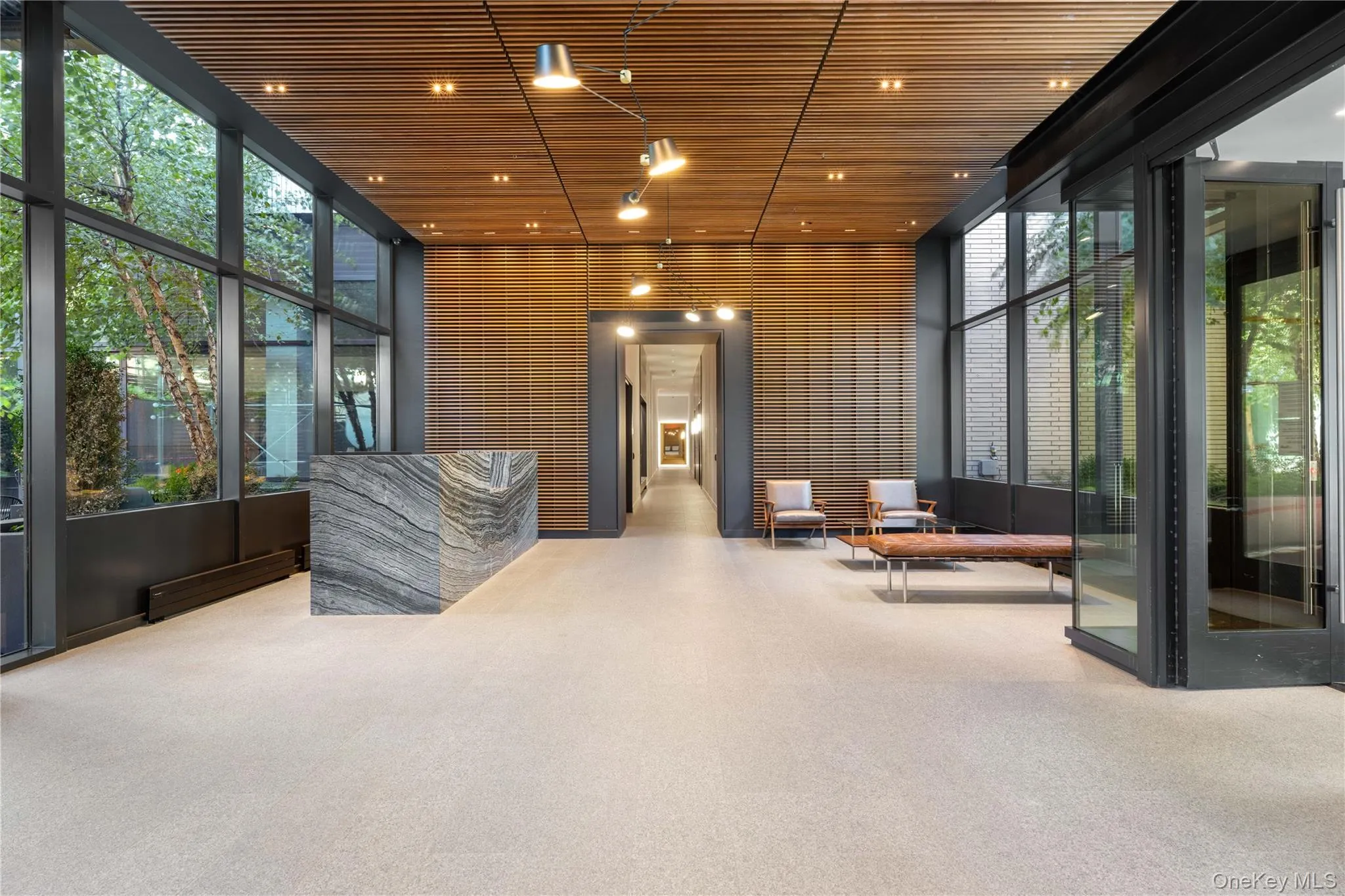 Community lobby with floor to ceiling windows and wooden ceiling Community lobby with floor to ceiling windows and wooden ceiling