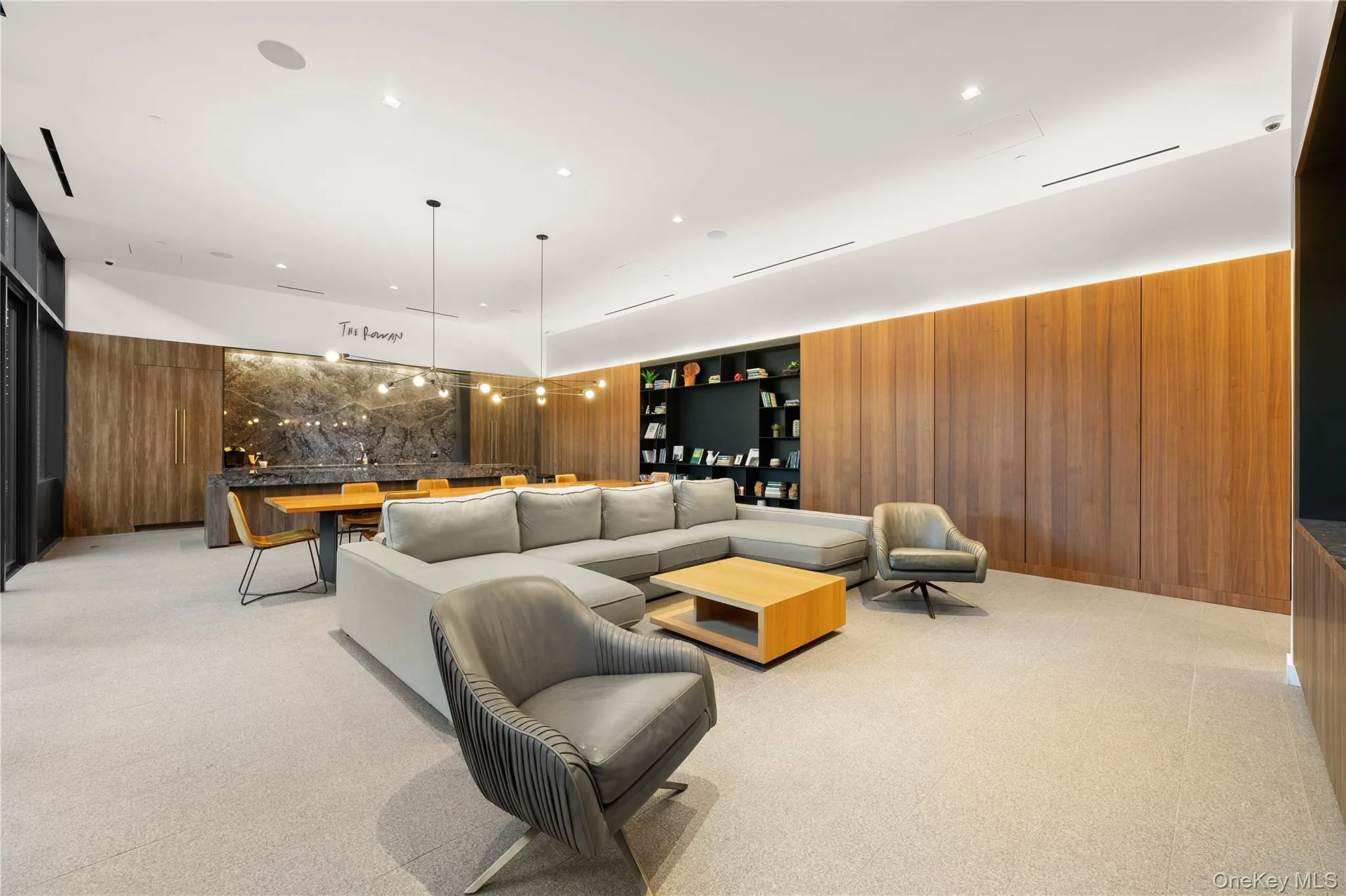 Living room featuring wood walls, light carpet, and recessed lighting Living room featuring wood walls, light carpet, and recessed lighting