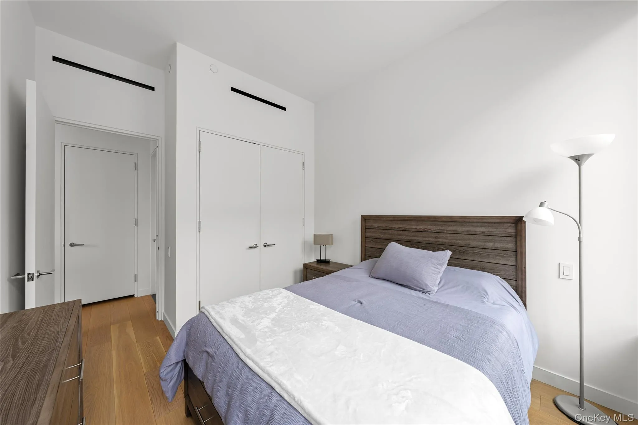 Bedroom with light wood-style flooring and a closet Bedroom with light wood-style flooring and a closet