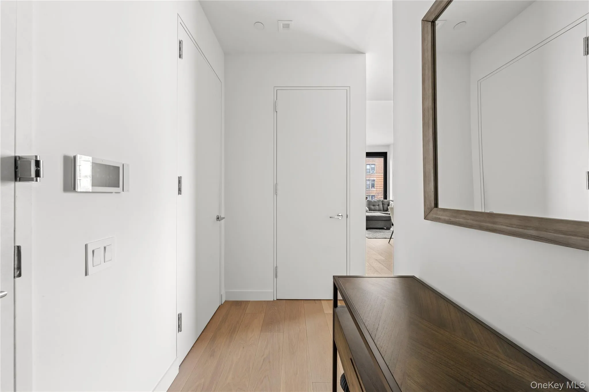 Hallway featuring light wood-style flooring Hallway featuring light wood-style flooring