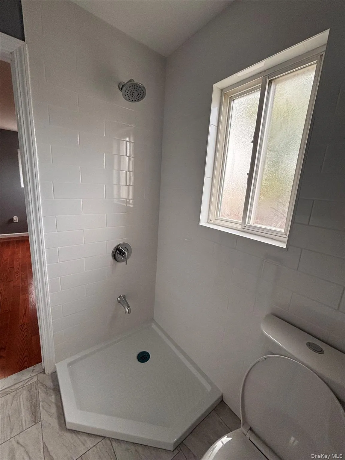 Shower with subway tile surround, chrome fixtures. Shower with subway tile surround, chrome fixtures.