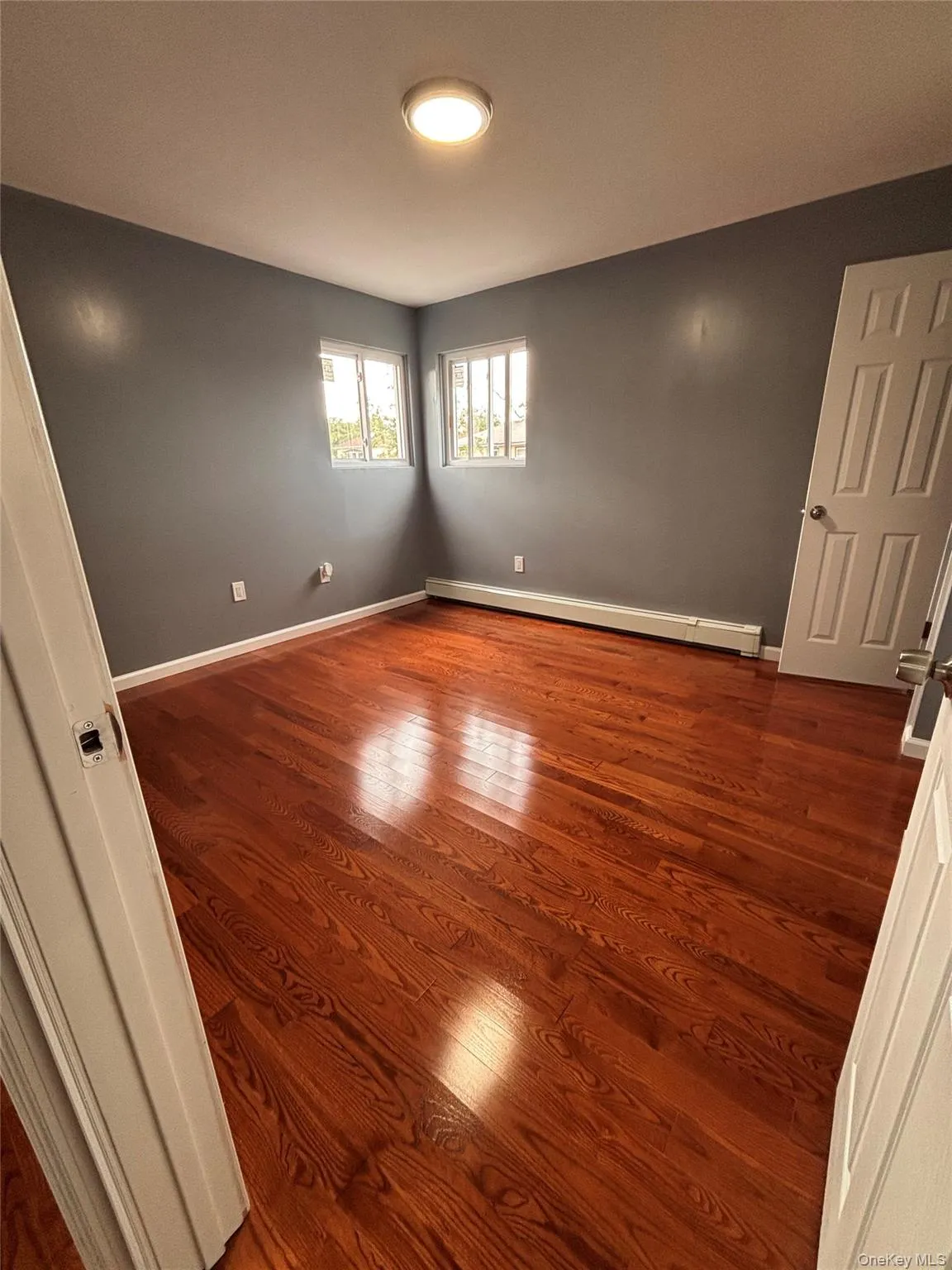 Hardwood flooring, and two windows Hardwood flooring, and two windows