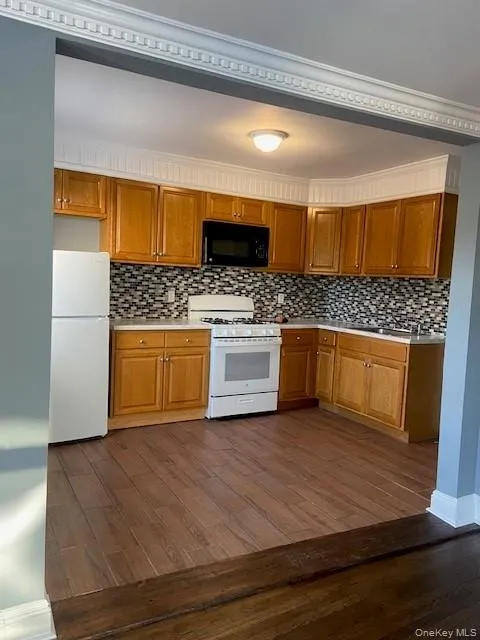 Fully renovated kitchen with new backsplash and new flooring Fully renovated kitchen with new backsplash and new flooring