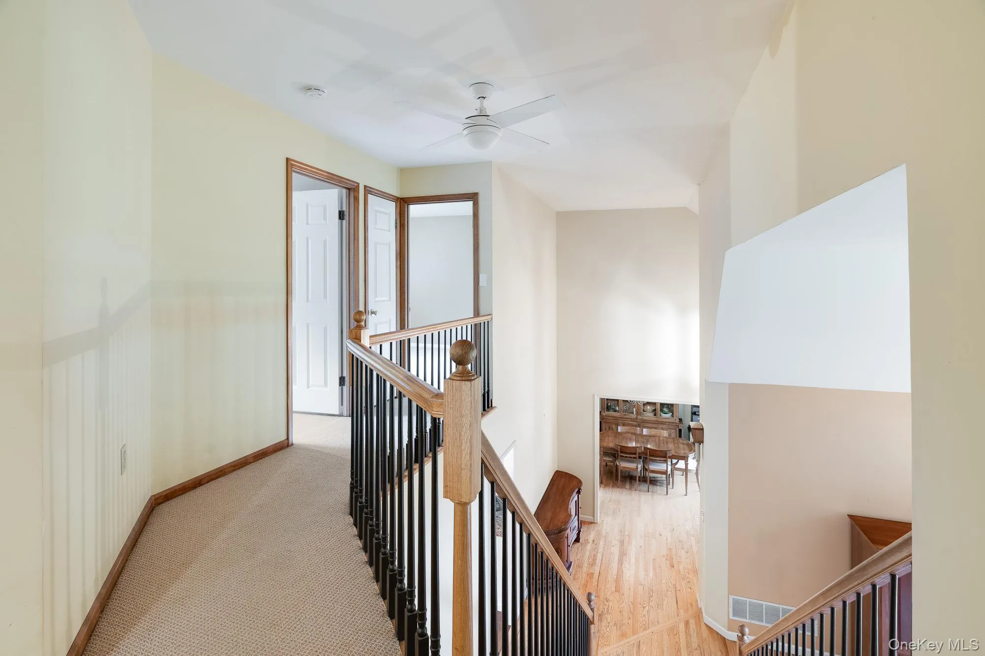 Hall featuring an upstairs landing and carpet Hall featuring an upstairs landing and carpet