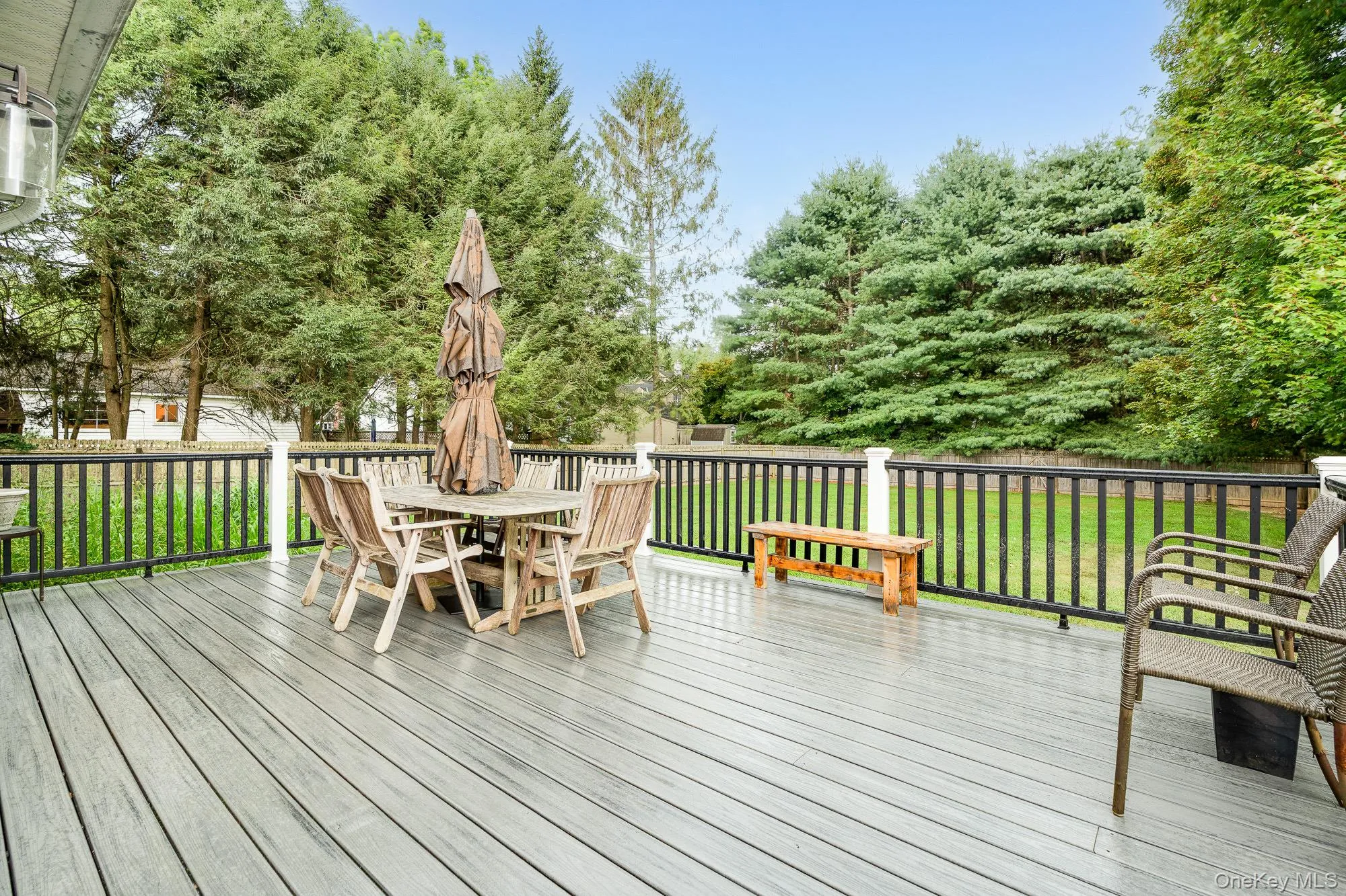 Wooden deck with outdoor dining area and a yard Wooden deck with outdoor dining area and a yard