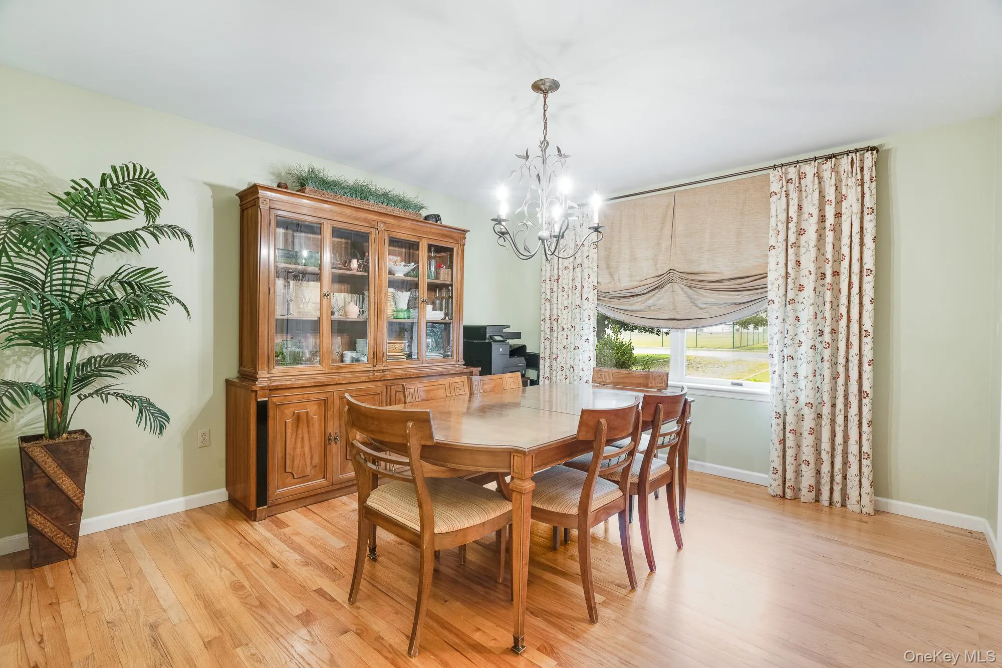 Dining room featuring a chandelier and light wood finished floors Dining room featuring a chandelier and light wood finished floors