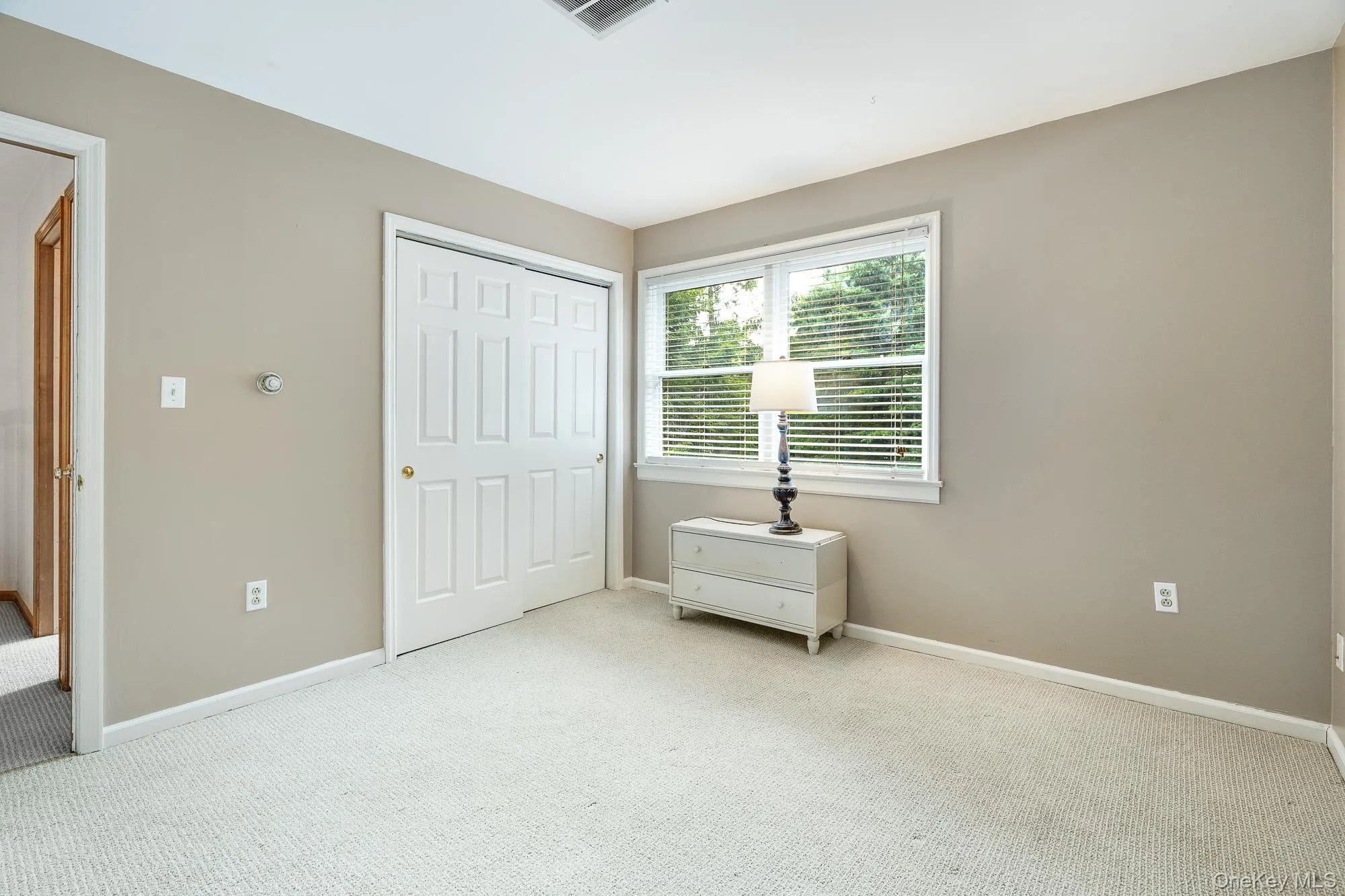Unfurnished bedroom with carpet floors and a closet Unfurnished bedroom with carpet floors and a closet