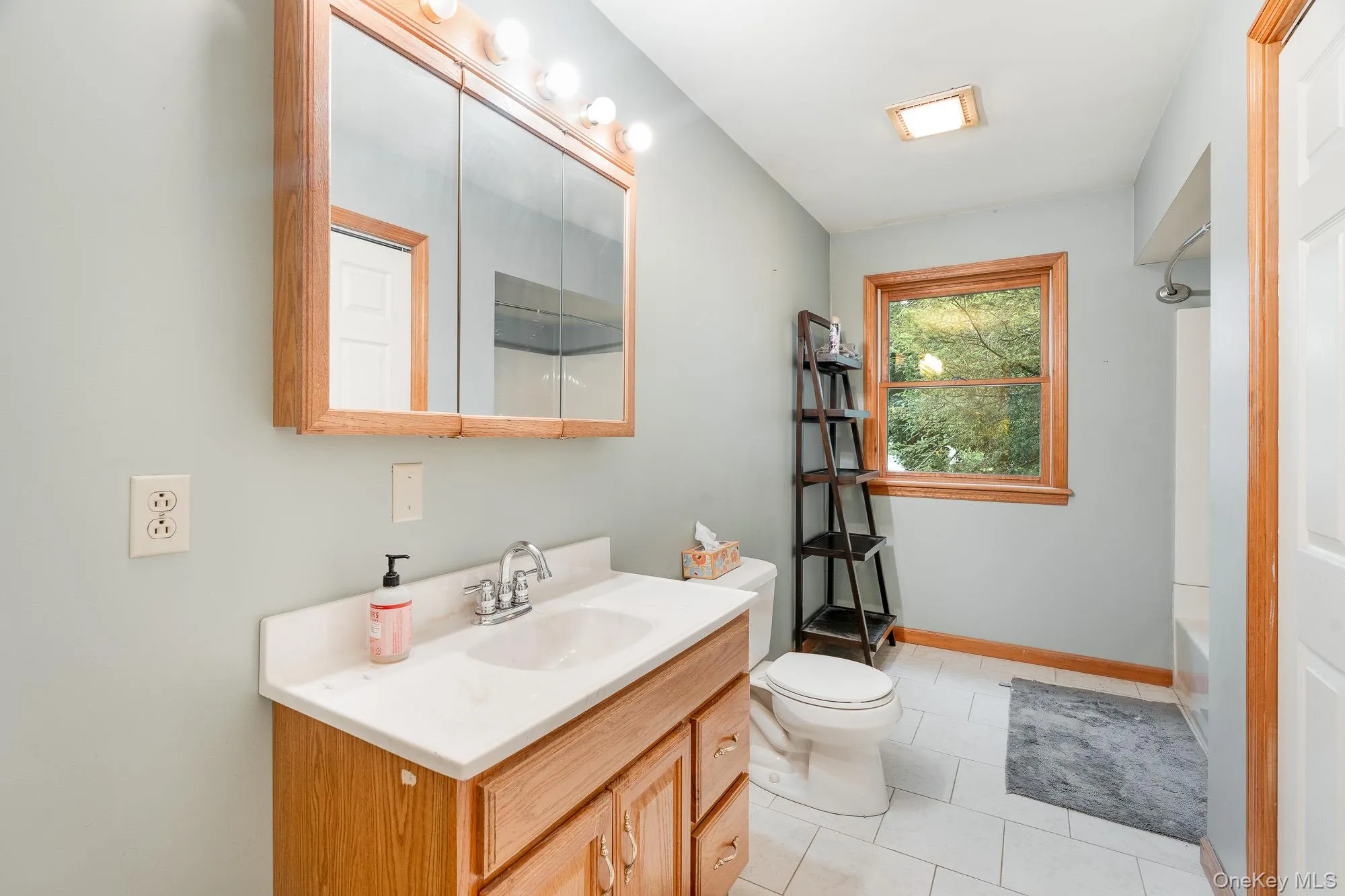 Bathroom featuring vanity, tub / shower combination, and light tile patterned flooring Bathroom featuring vanity, tub / shower combination, and light tile patterned flooring