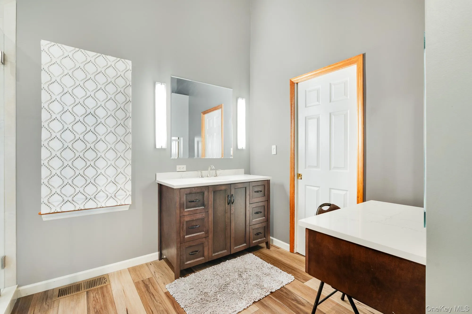 Bathroom featuring vanity and light wood-style floors Bathroom featuring vanity and light wood-style floors