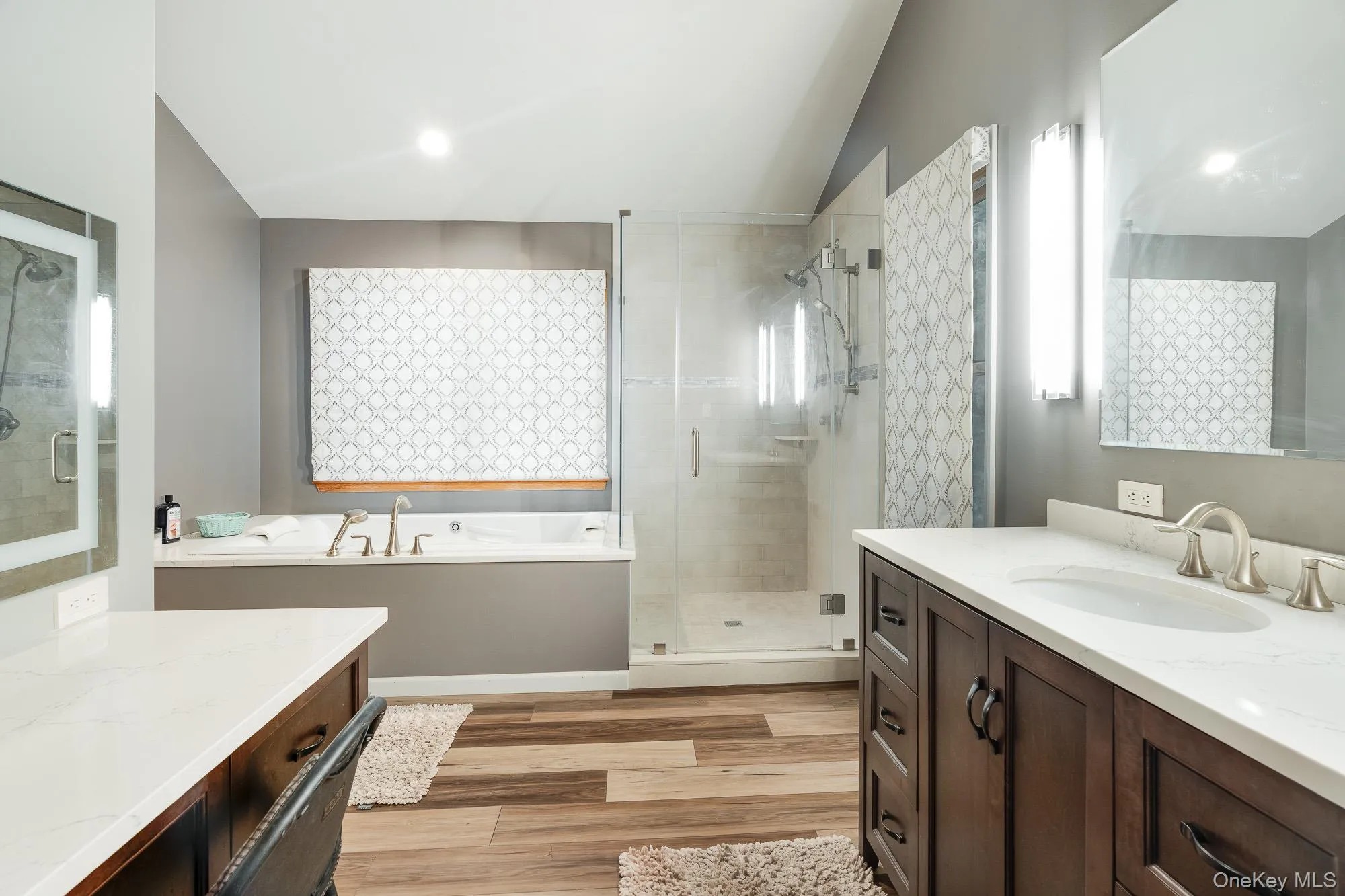 Bathroom with vanity, a stall shower, a bath, light wood-style flooring, and recessed lighting Bathroom with vanity, a stall shower, a bath, light wood-style flooring, and recessed lighting