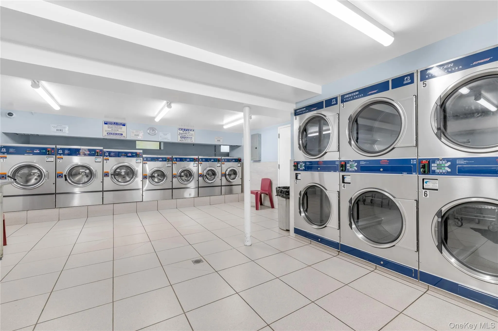Laundry facility featuring multiple front-loading washers and dryers. Laundry facility featuring multiple front-loading washers and dryers.