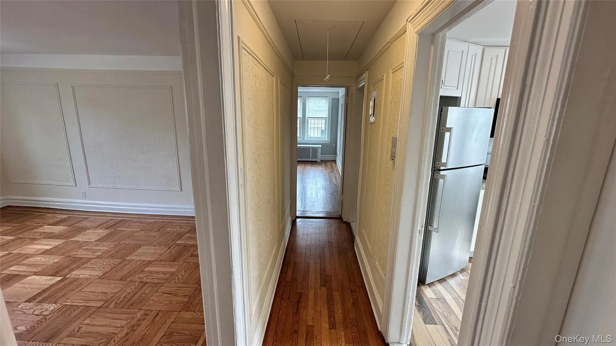 Hardwood flooring, wall paneling, and stainless steel appliances Hardwood flooring, wall paneling, and stainless steel appliances