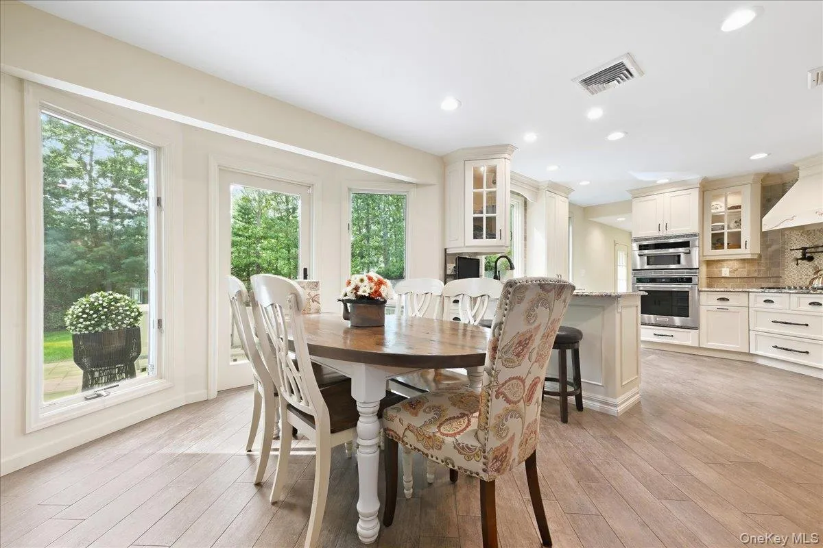 Hardwood-finish flooring, recessed lighting, white cabinetry. Hardwood-finish flooring, recessed lighting, white cabinetry.