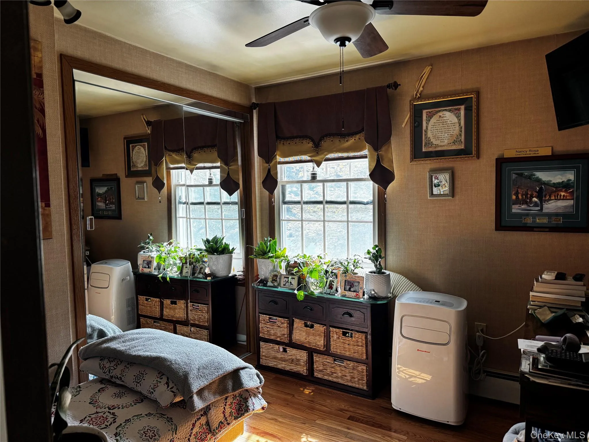 Wood-finish flooring with a ceiling fan overhead Wood-finish flooring with a ceiling fan overhead