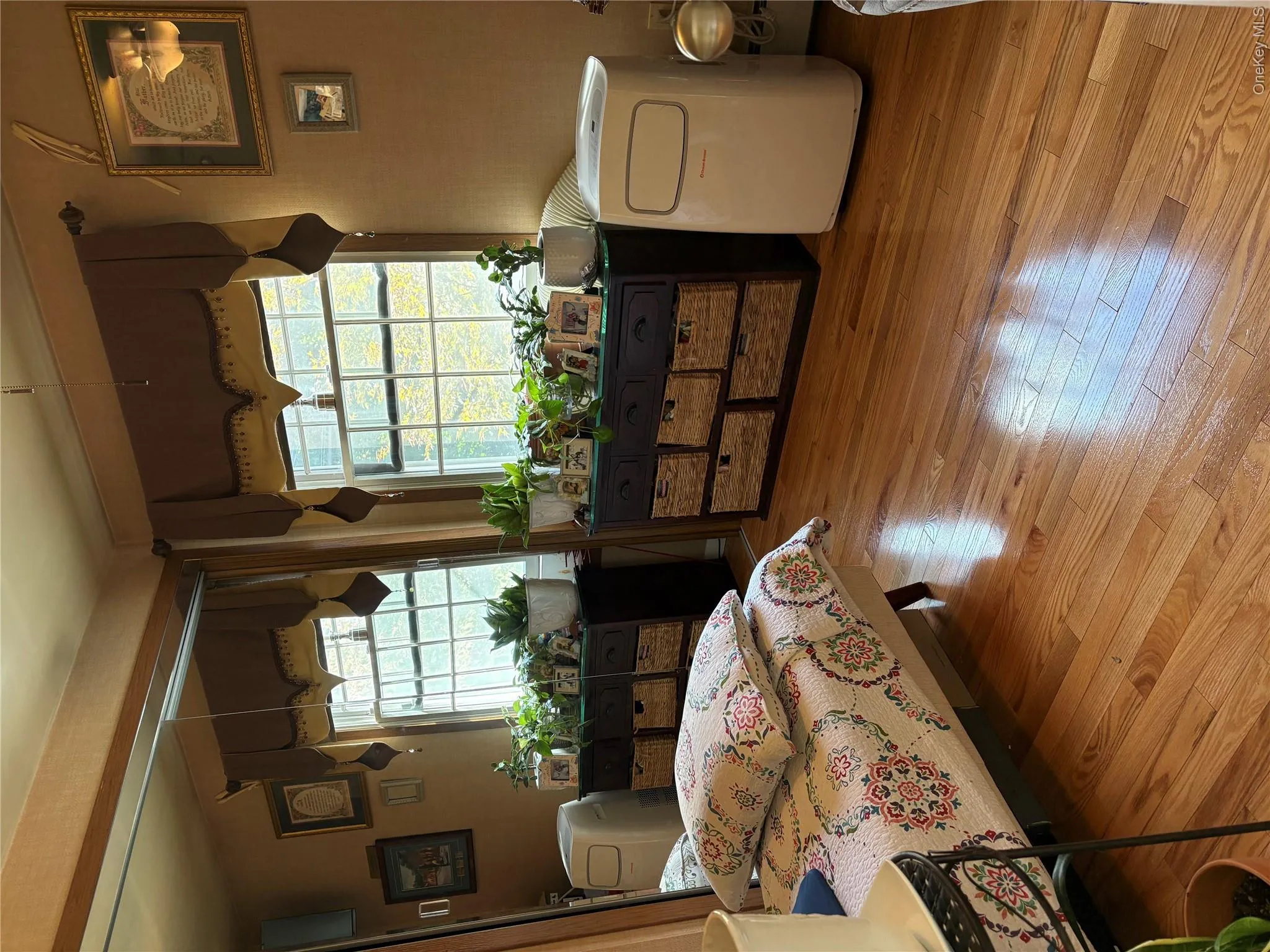 Hardwood flooring, dual windows, built-in shelving, and a mirrored wall Hardwood flooring, dual windows, built-in shelving, and a mirrored wall