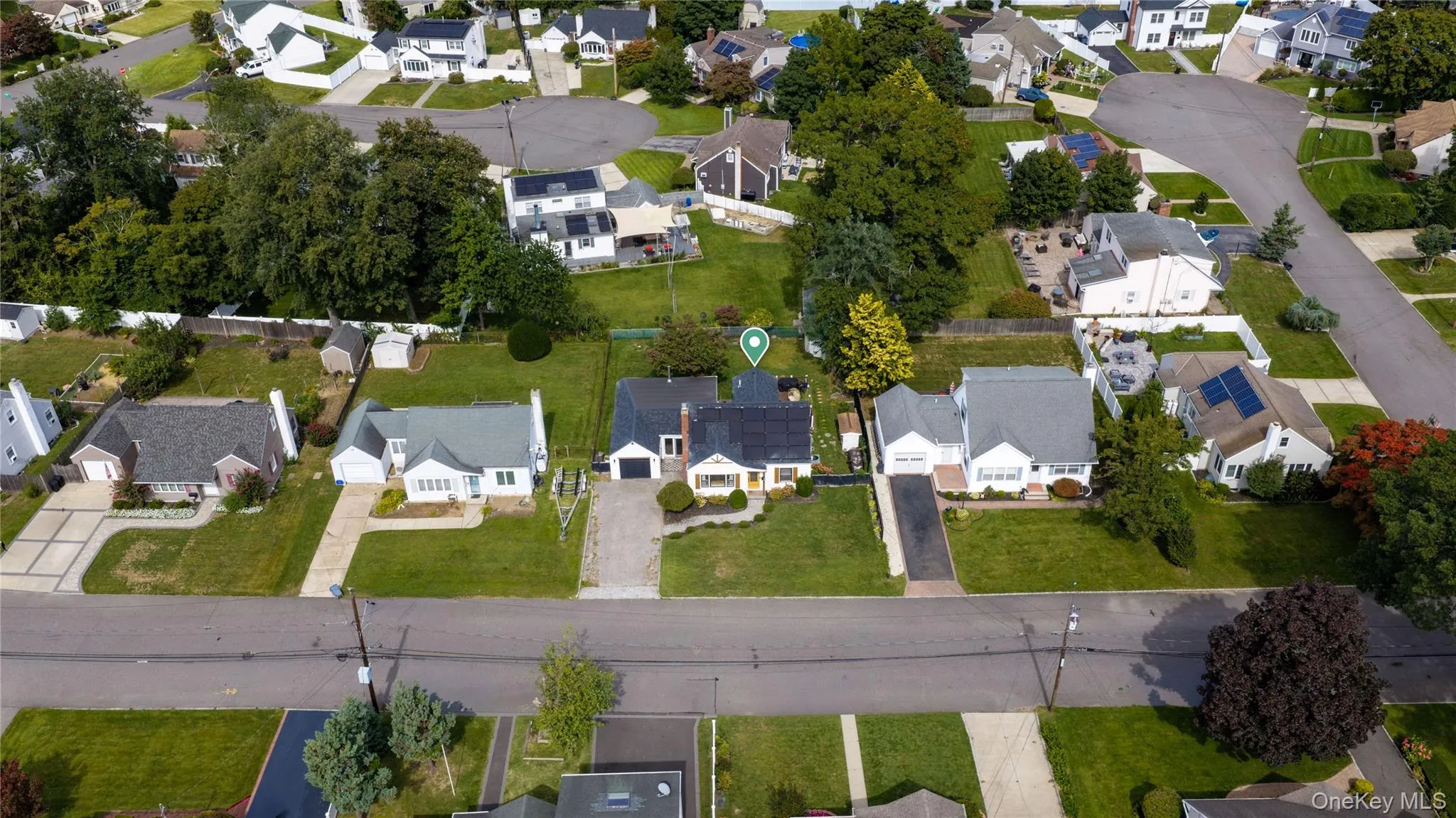 Residential street featuring multiple single-story homes with well-maintained lawns Residential street featuring multiple single-story homes with well-maintained lawns