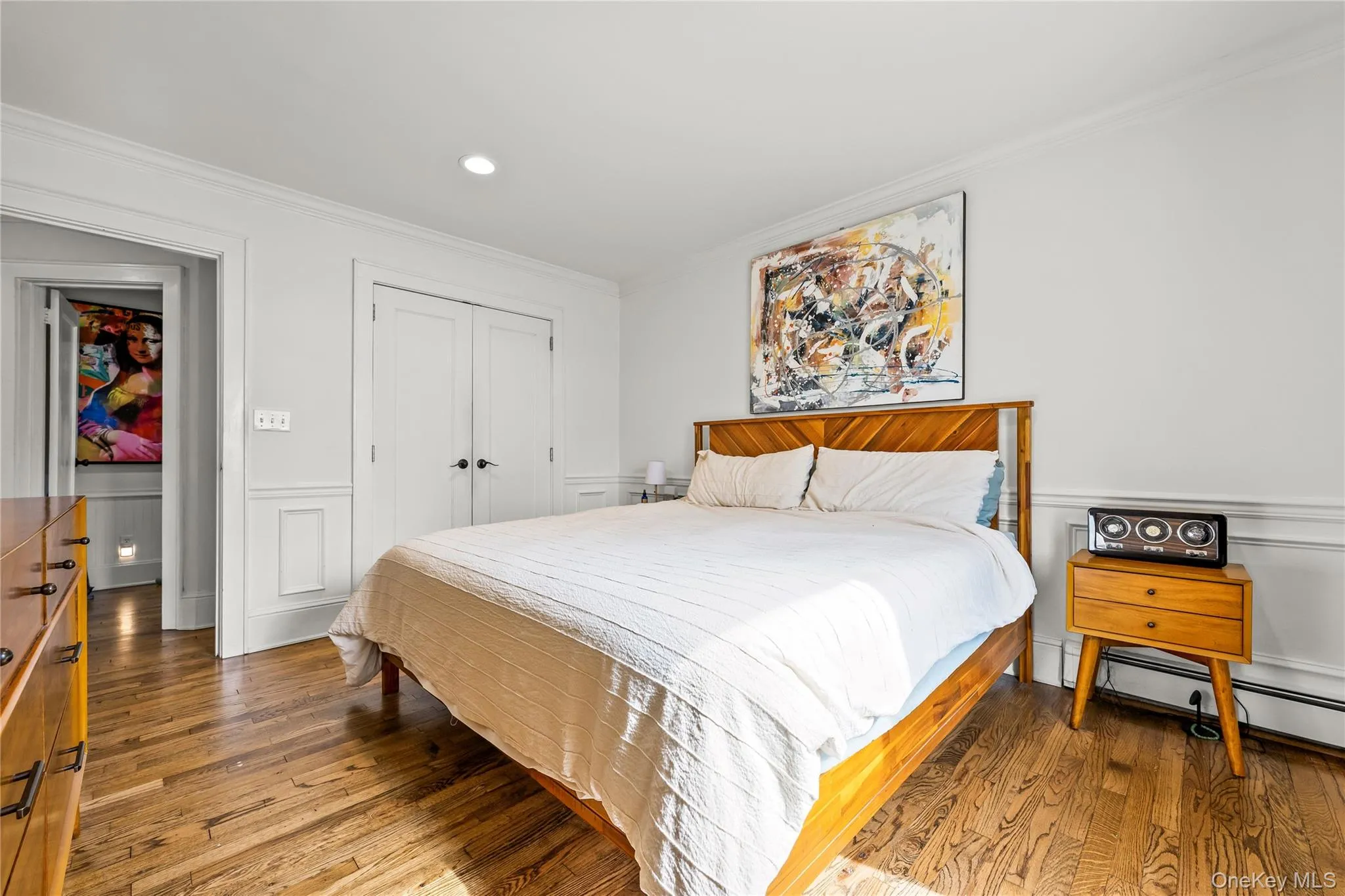 Hardwood flooring, recessed lighting, crown molding, double-door closet, and wainscoting Hardwood flooring, recessed lighting, crown molding, double-door closet, and wainscoting