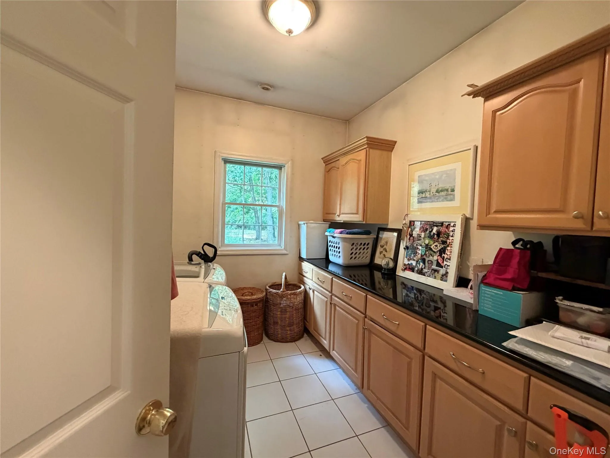 Matching cabinets, stone countertops and a utility sink offer a lot of added storage and functionality to this great laundry room. Matching cabinets, stone countertops and a utility sink offer a lot of added storage and functionality to this great laundry room.