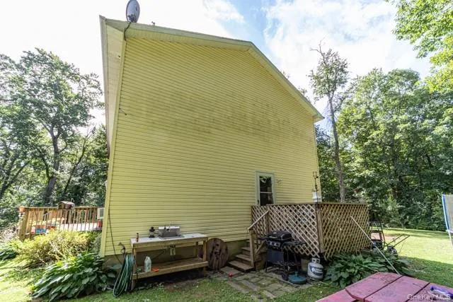 Siding exterior with a rear deck featuring wood lattice railing Siding exterior with a rear deck featuring wood lattice railing