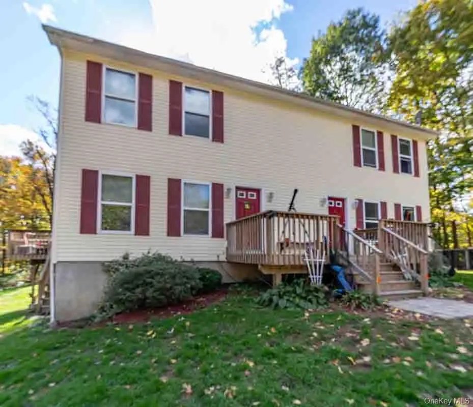 Yellow siding exterior with red window shutters Yellow siding exterior with red window shutters