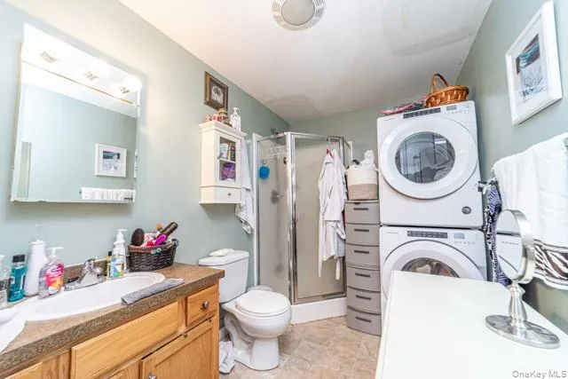 Vanity with an integrated sink, wood-finish cabinetry, and a wall-mounted mirror Vanity with an integrated sink, wood-finish cabinetry, and a wall-mounted mirror