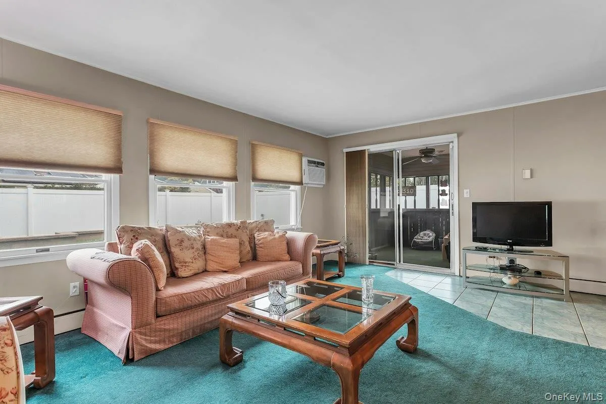 Enclosed Porch off Living Room with access to Rear Yard Enclosed Porch off Living Room with access to Rear Yard