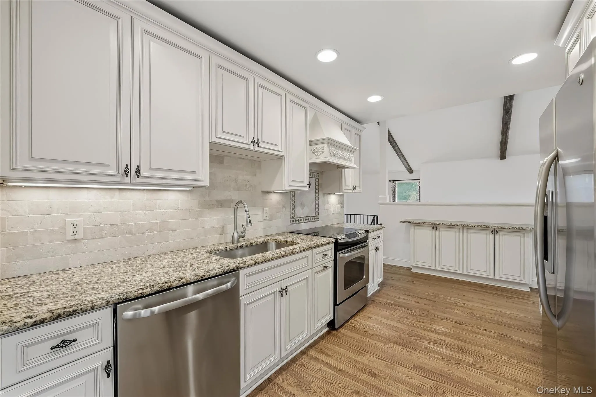 Elegant white kitchen w/ pantry, granite countertops, & custom cabinetry. Elegant white kitchen w/ pantry, granite countertops, & custom cabinetry.