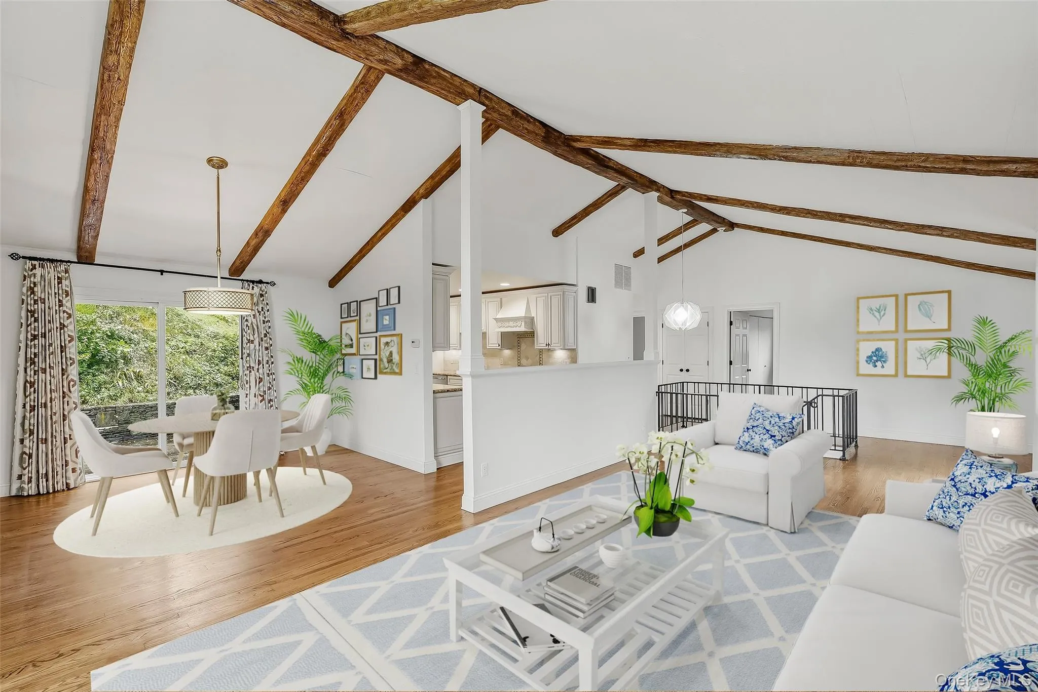 Virtually staged open-plan great room w/ hardwood floors, exposed wood beams, and fresh paint. Virtually staged open-plan great room w/ hardwood floors, exposed wood beams, and fresh paint.