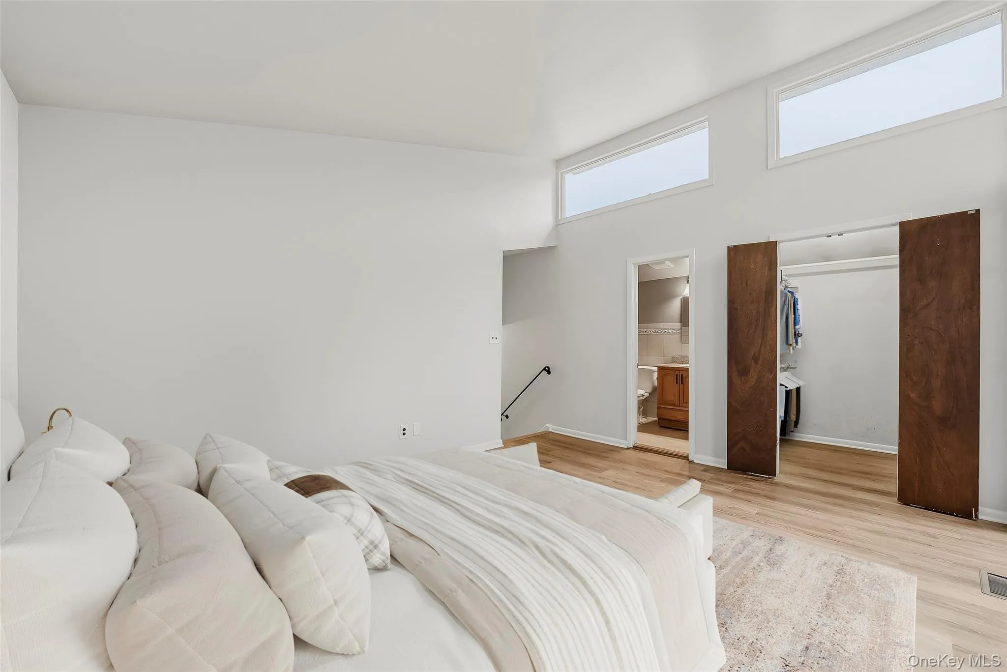Virtually staged primary bedroom with brand new floors, en-suite bathroom, & walk-in closet. Virtually staged primary bedroom with brand new floors, en-suite bathroom, & walk-in closet.
