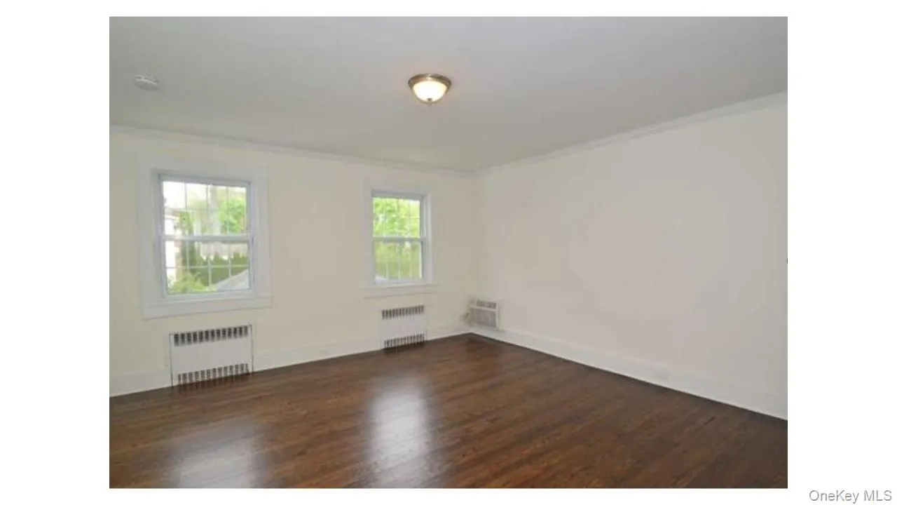 Dark wood-finish flooring with white trim Dark wood-finish flooring with white trim