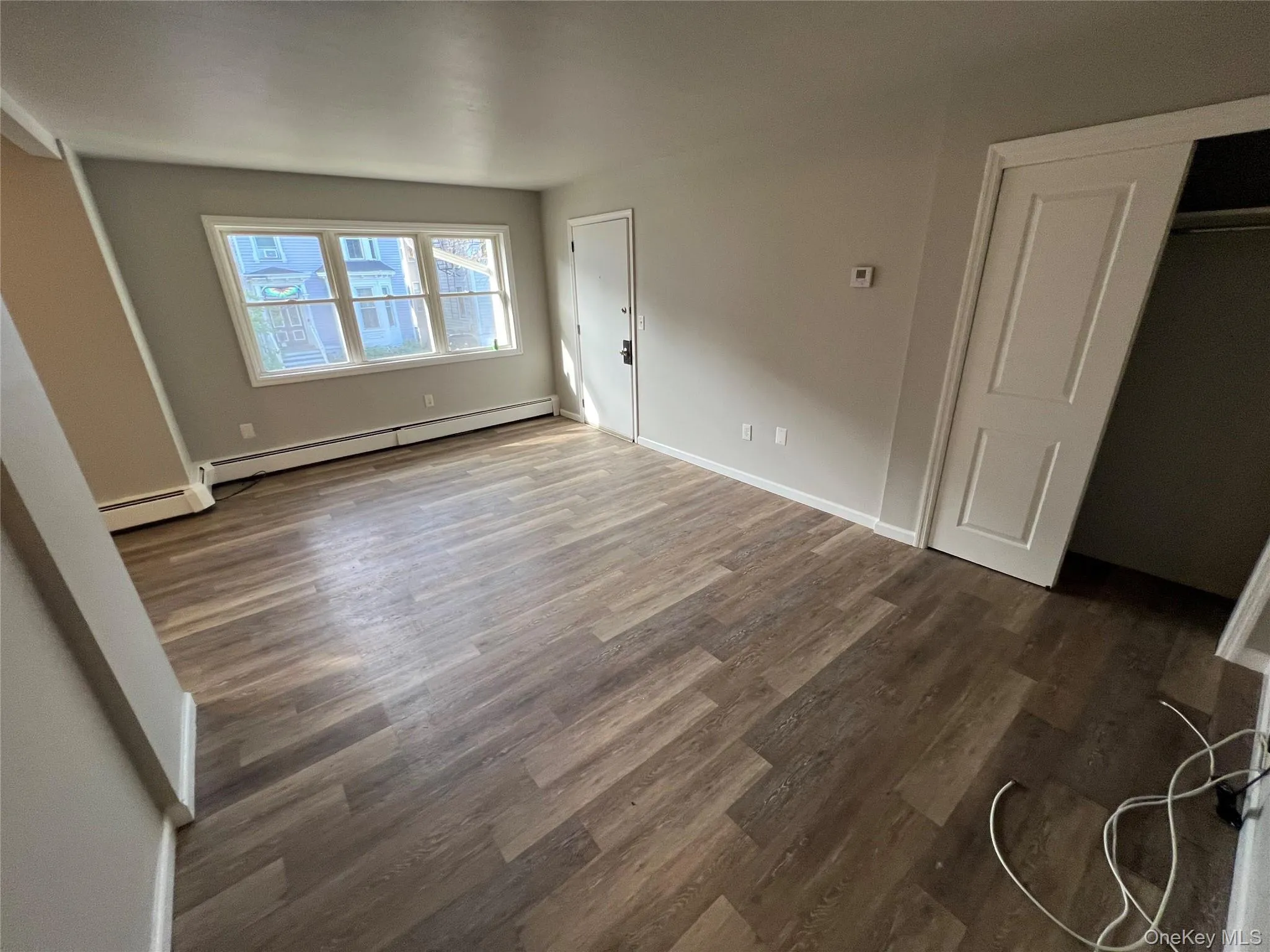 Wood-finish flooring throughout, multiple windows, and a built-in closet with sliding doors Wood-finish flooring throughout, multiple windows, and a built-in closet with sliding doors