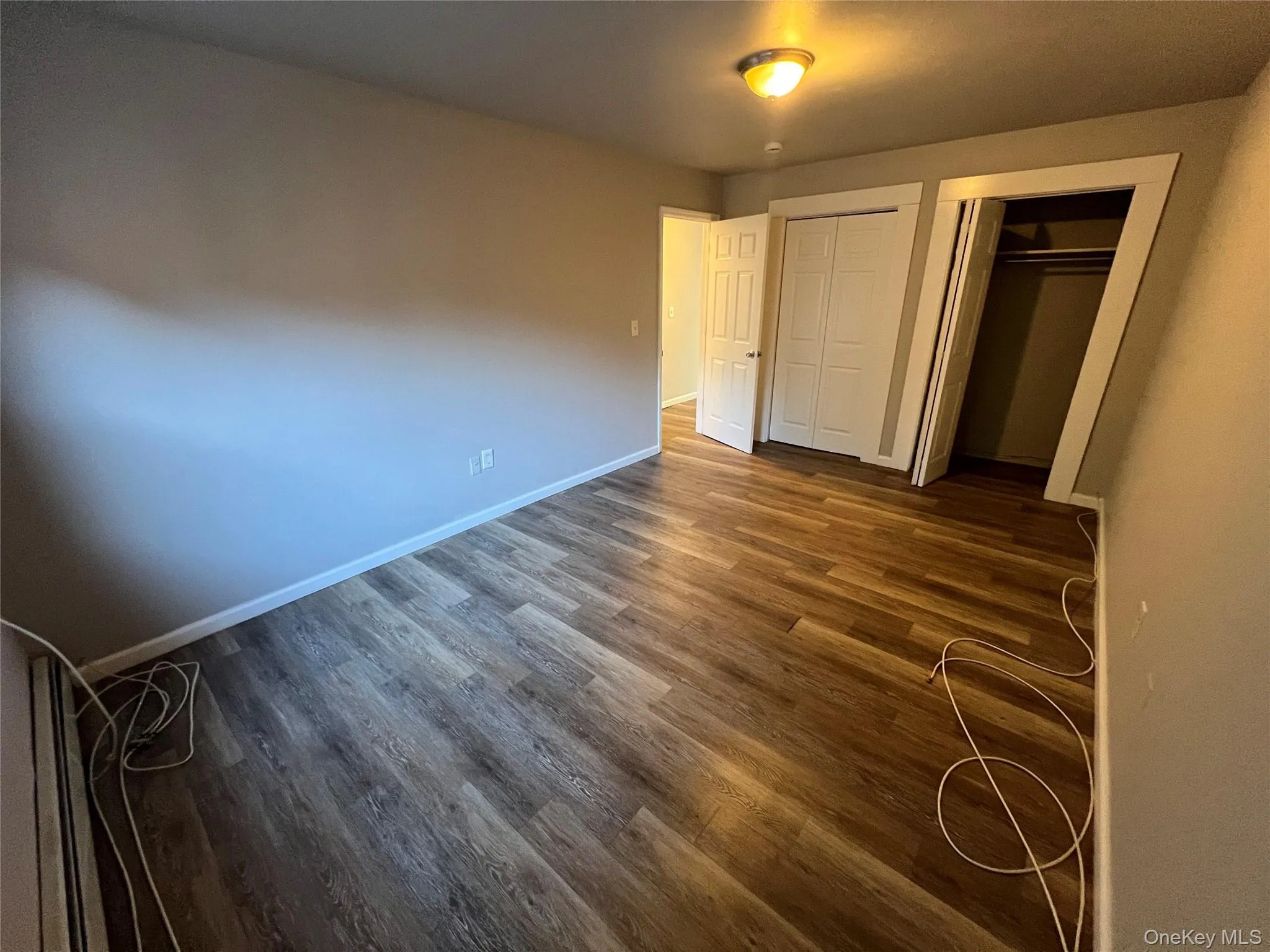 Wood-finish flooring with neutral wall tones and white trim Wood-finish flooring with neutral wall tones and white trim