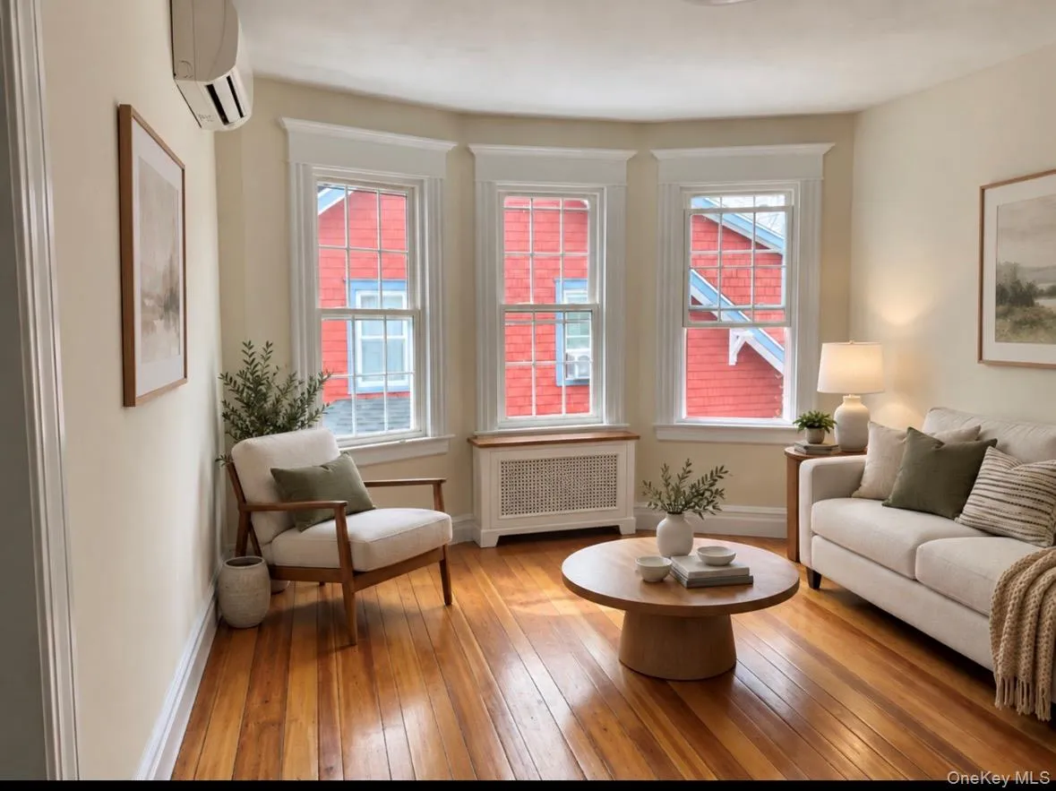 virtually staged with furniture- wall heating/cooling unit-hardwood floors-3 windows virtually staged with furniture- wall heating/cooling unit-hardwood floors-3 windows