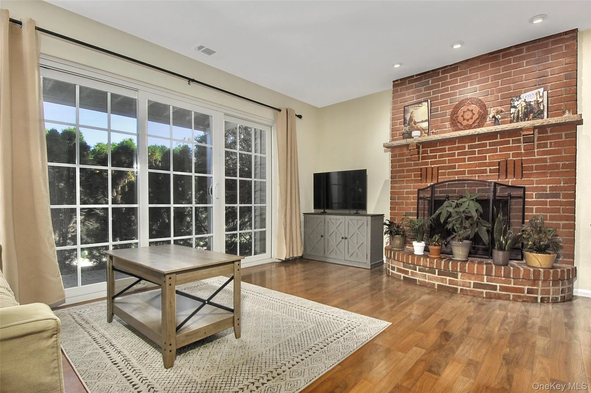 with brick fireplace & sliding glass door to private patio with brick fireplace & sliding glass door to private patio