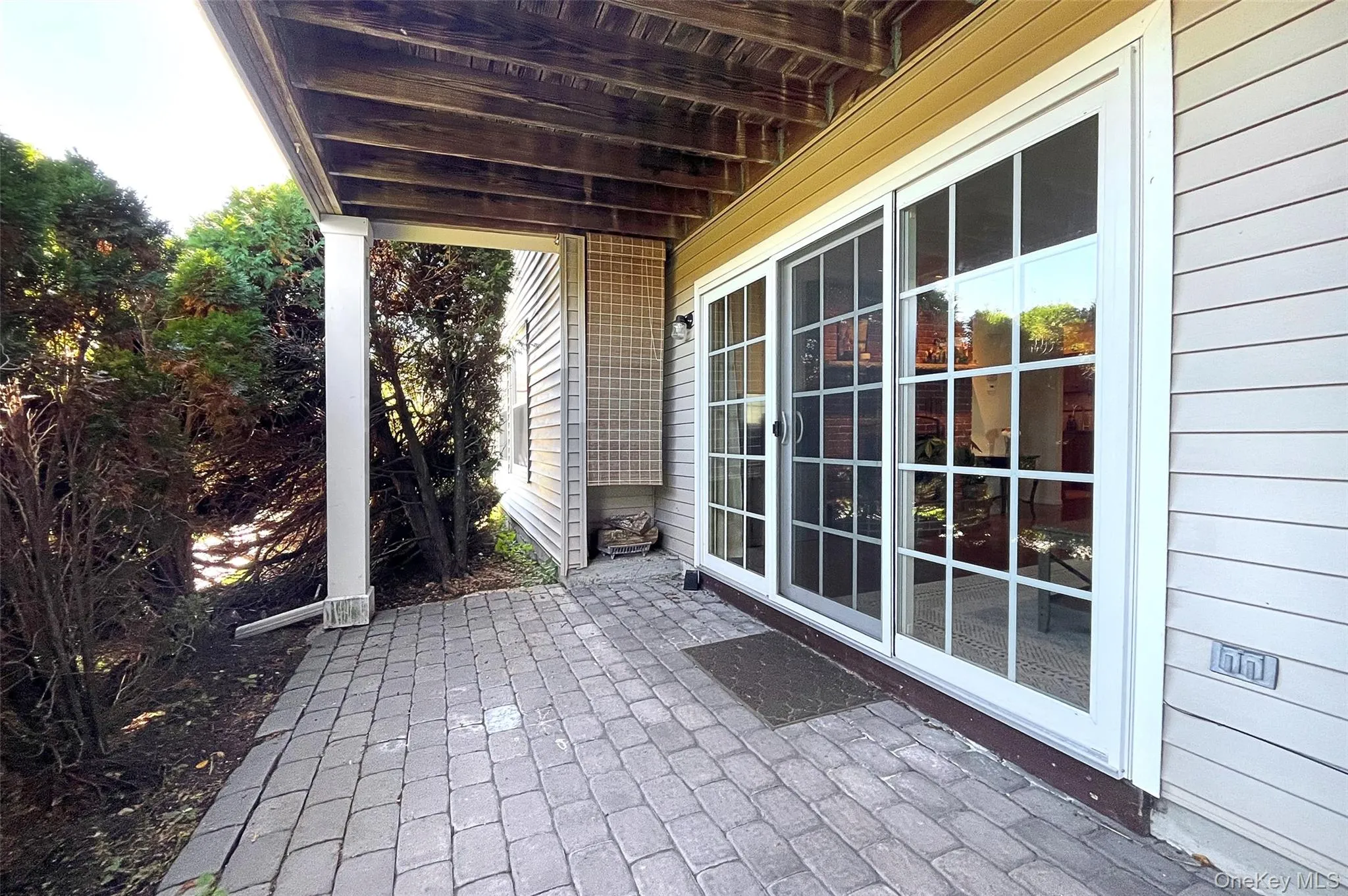 Sliding glass doors from living room to private stone patio Sliding glass doors from living room to private stone patio
