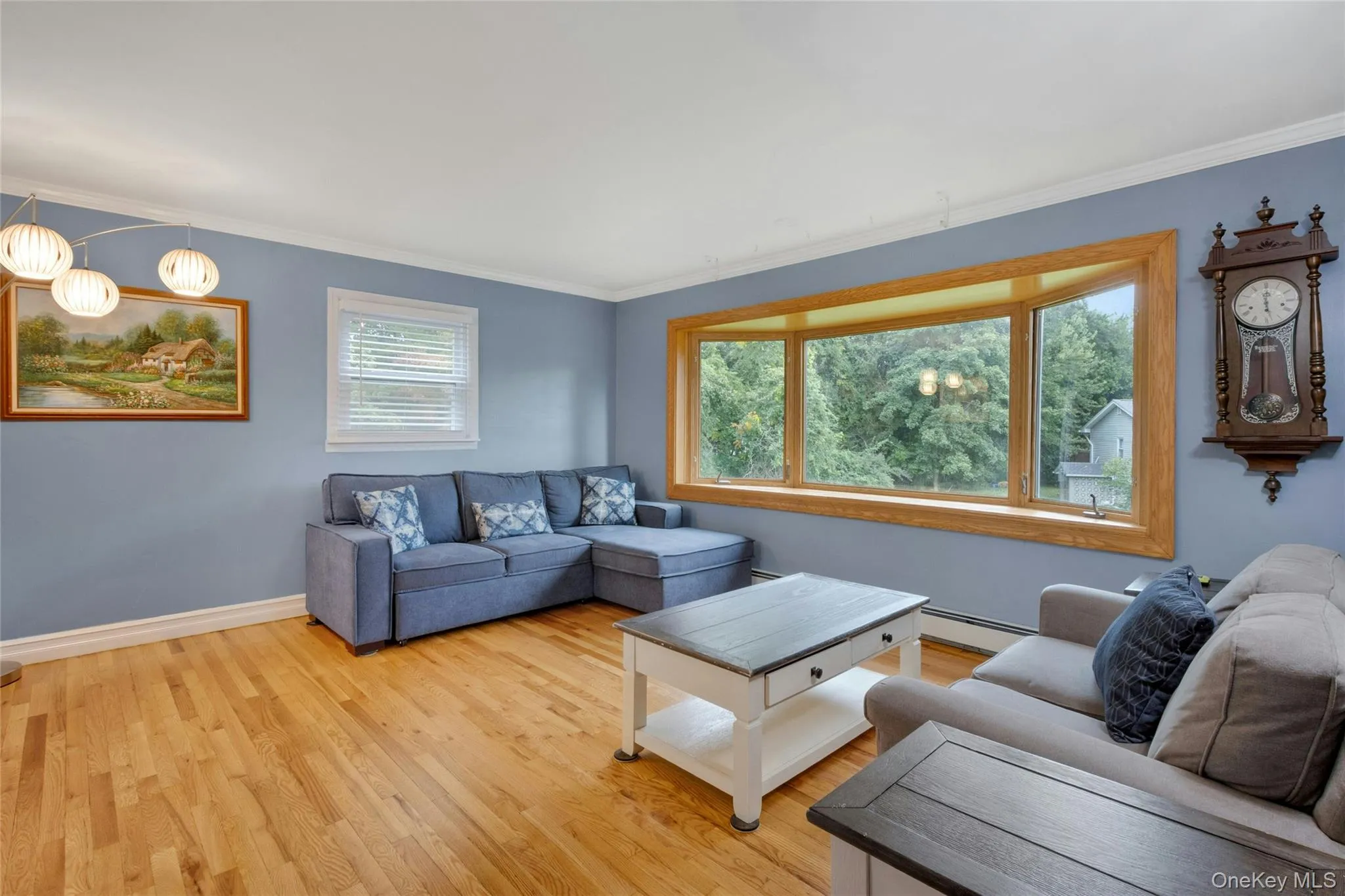 Hardwood flooring, bay window with wood trim, crown molding, and recessed lighting Hardwood flooring, bay window with wood trim, crown molding, and recessed lighting
